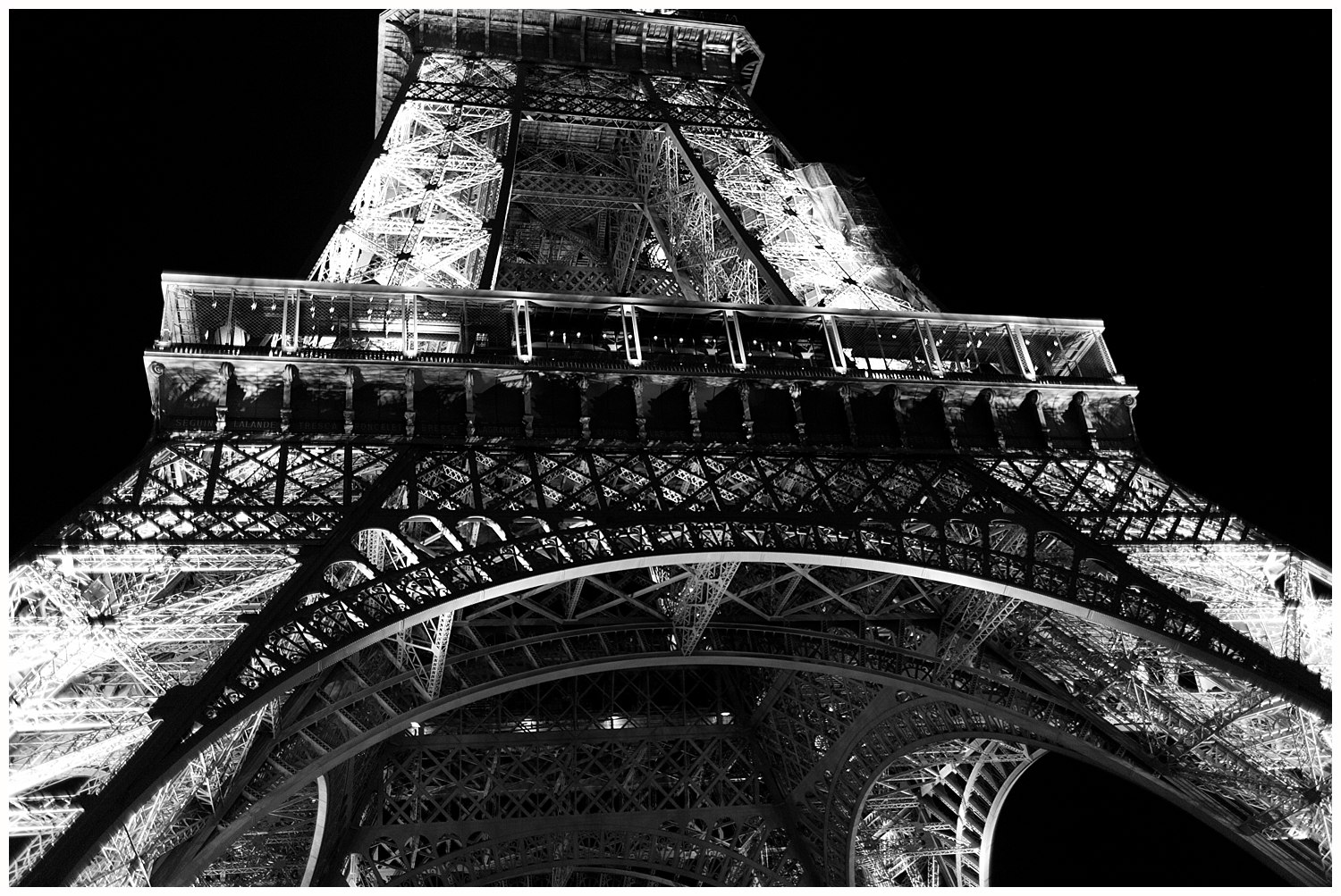 Eiffel Tower in black and white at night from below