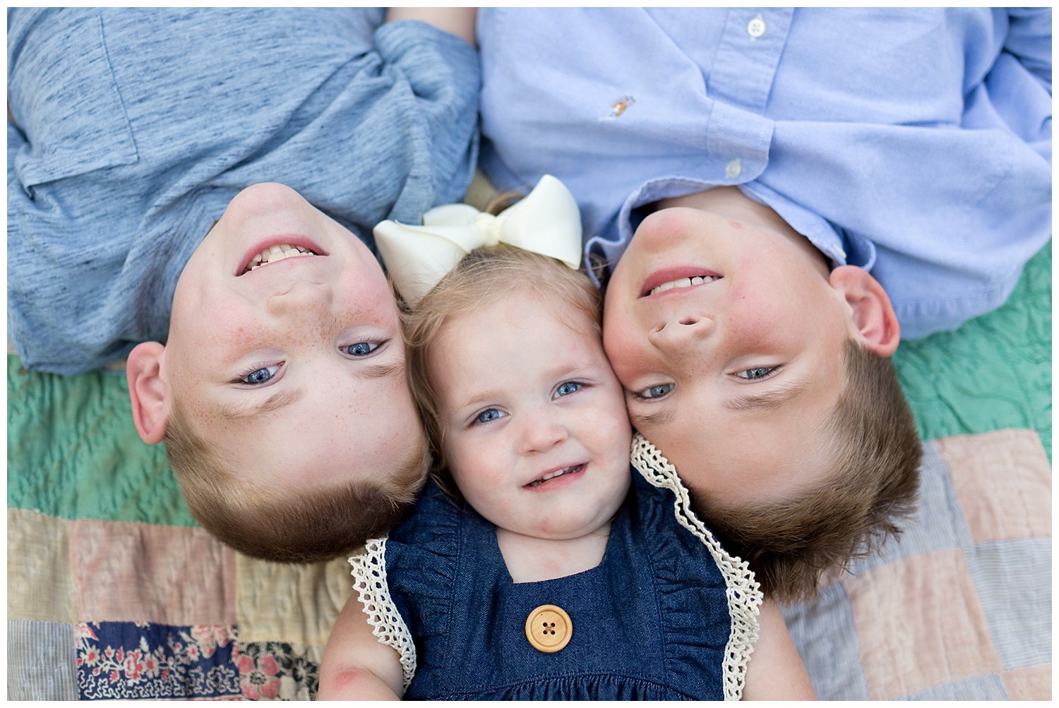 adorable siblings lying on vintage quilt - Ocean Springs children's photographer
