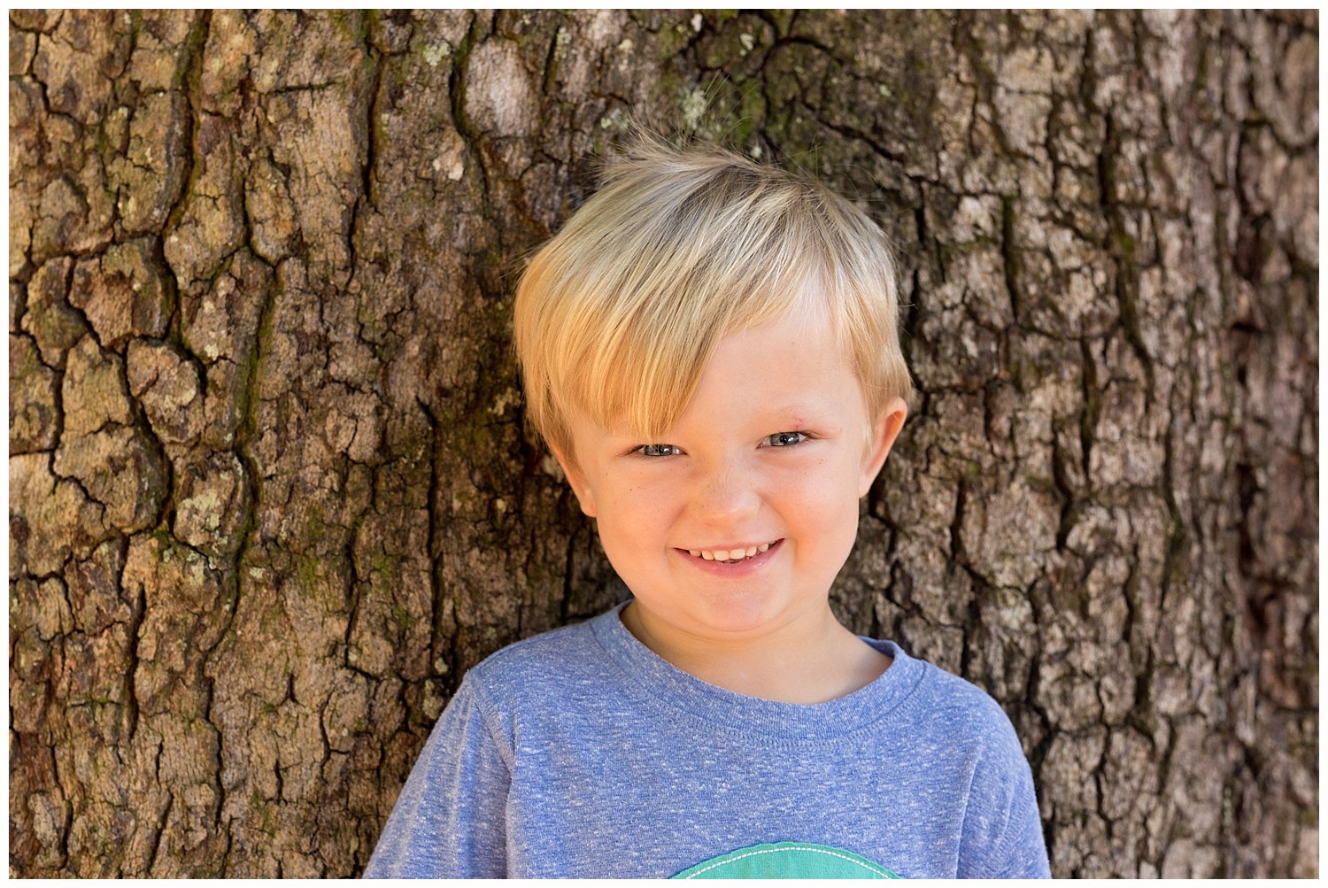 cute little boy with live oak tree bark background