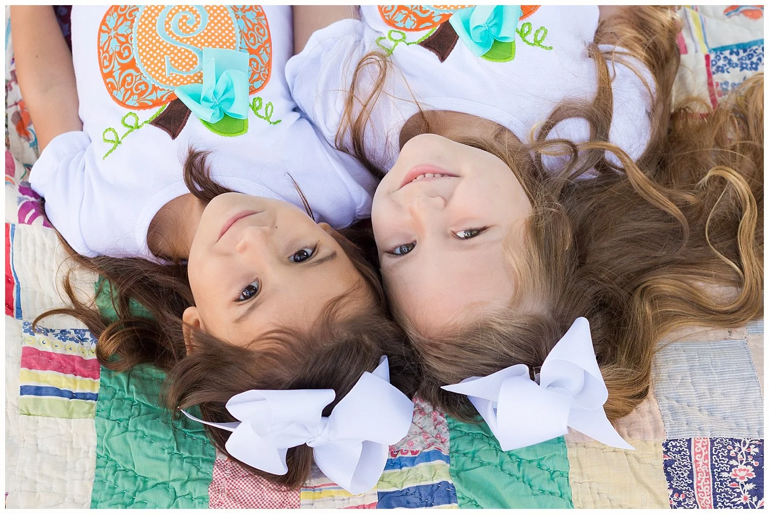 Ocean Springs family photographer - twin girls portrait on vintage quilt