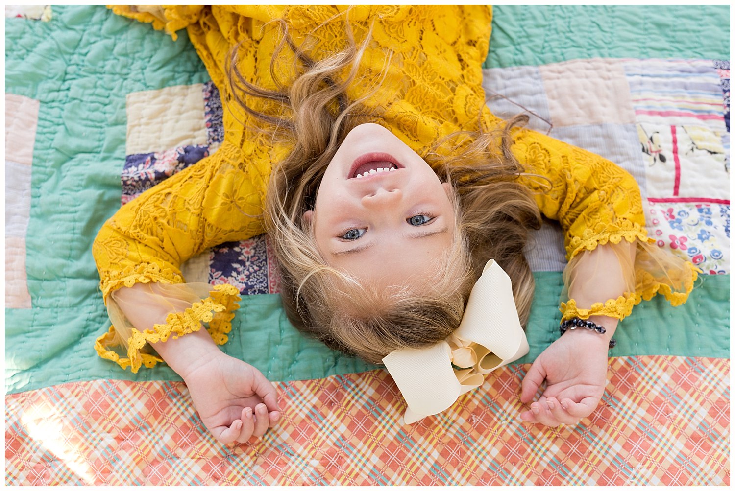 Ocean Springs photographer - colorful portrait of little girl on vintage quilt