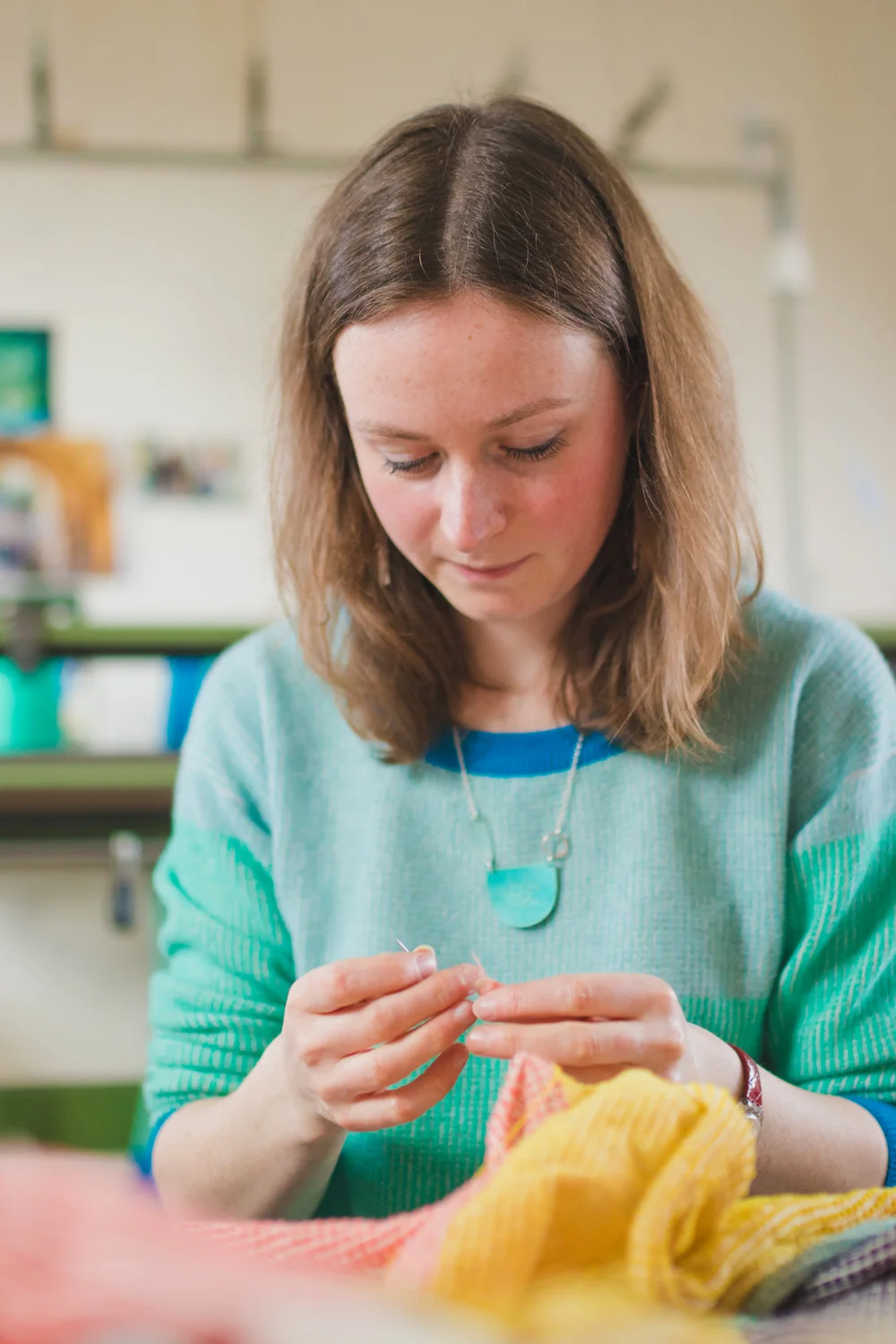 Sewing in ends by hand.