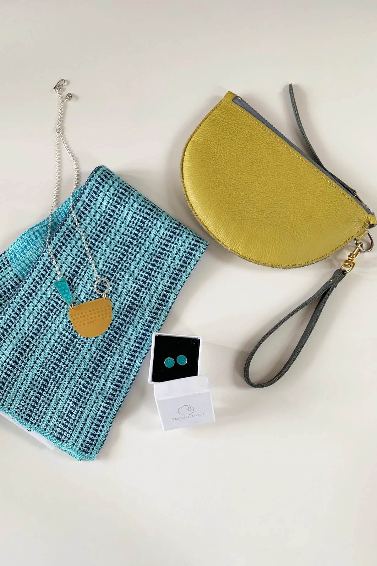 Earrings and necklace by Caroline Finlay. Wristlet purse by Jude Gove