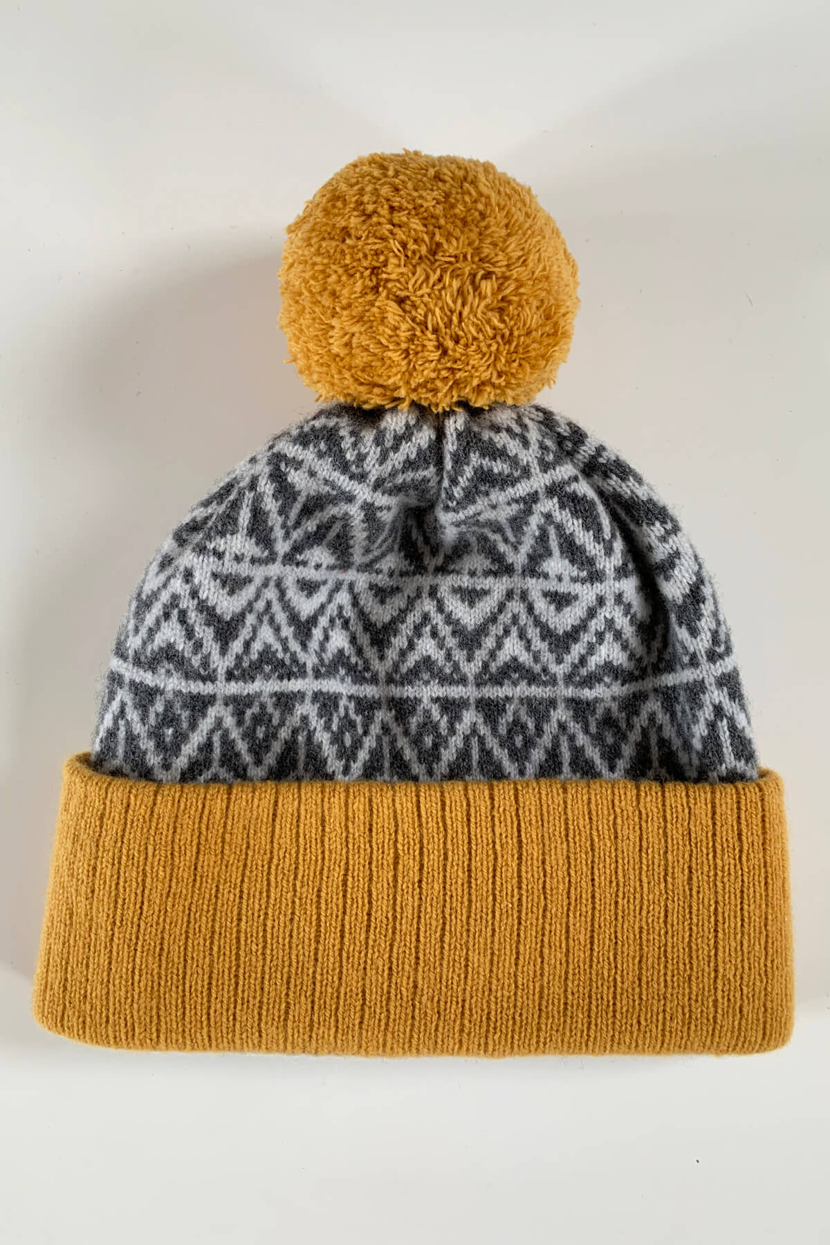 Limited Edition bobble hat in Mustard Yellow and grey. Made in Scotland with premium lambswool by Collingwood-Norris