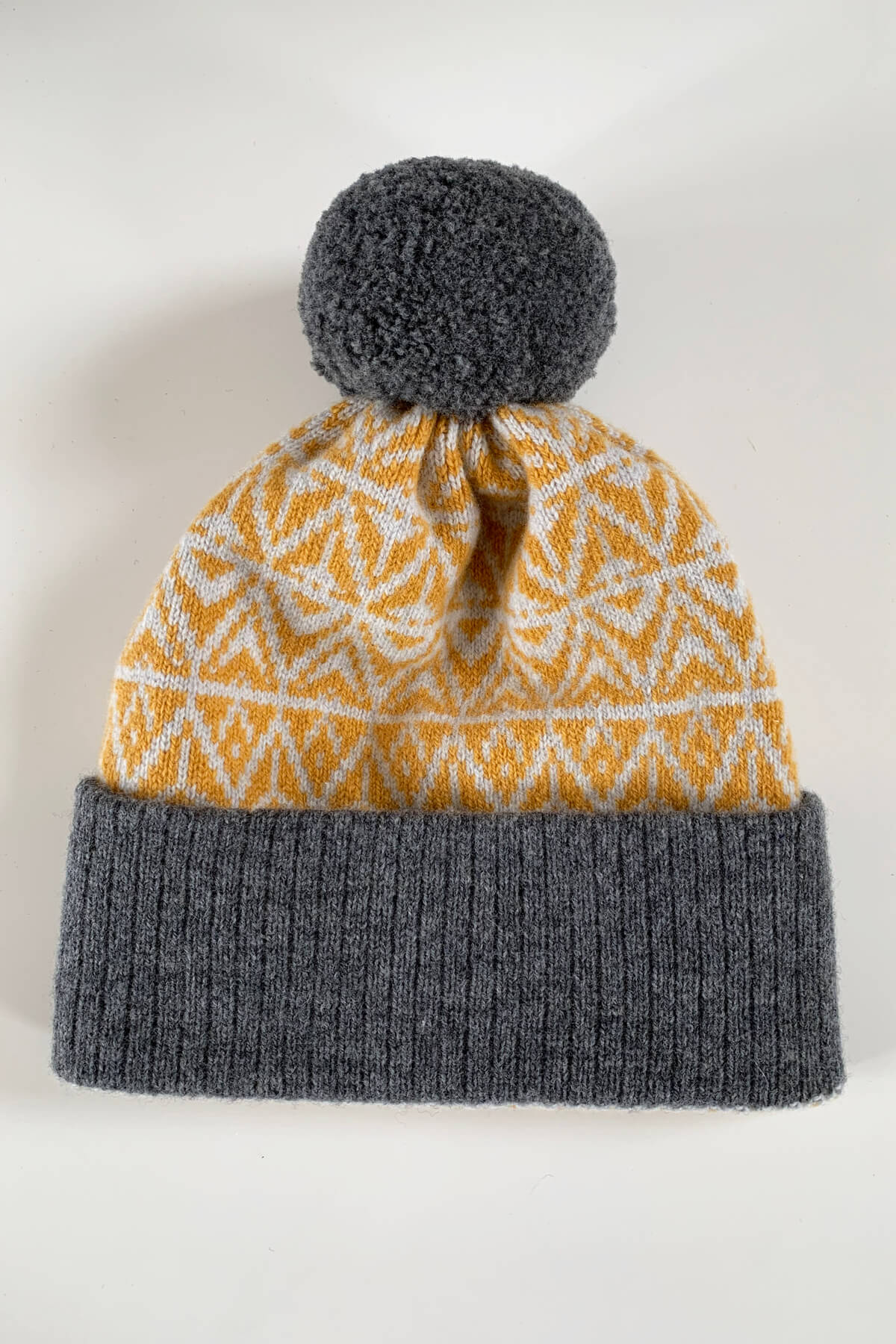 Limited Edition bobble hat in Mustard Yellow and grey. Made in Scotland with premium lambswool by Collingwood-Norris