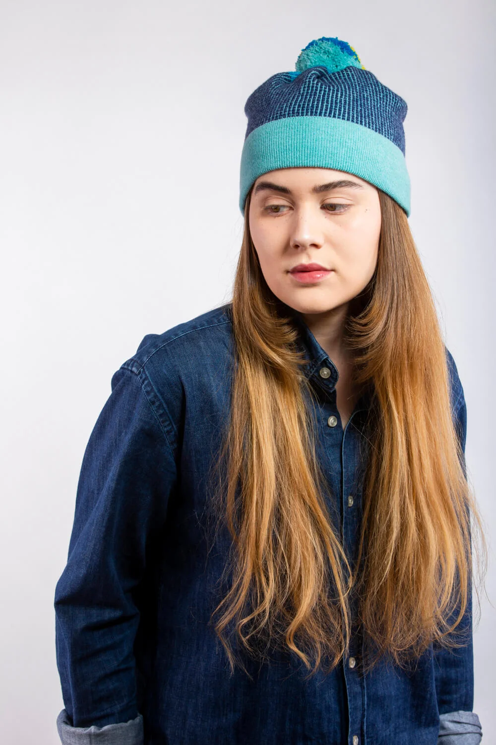 Designer lambswool bobble hat in aqua blue, by Collingwood-Norris. Luxury Knitwear made in Scotland