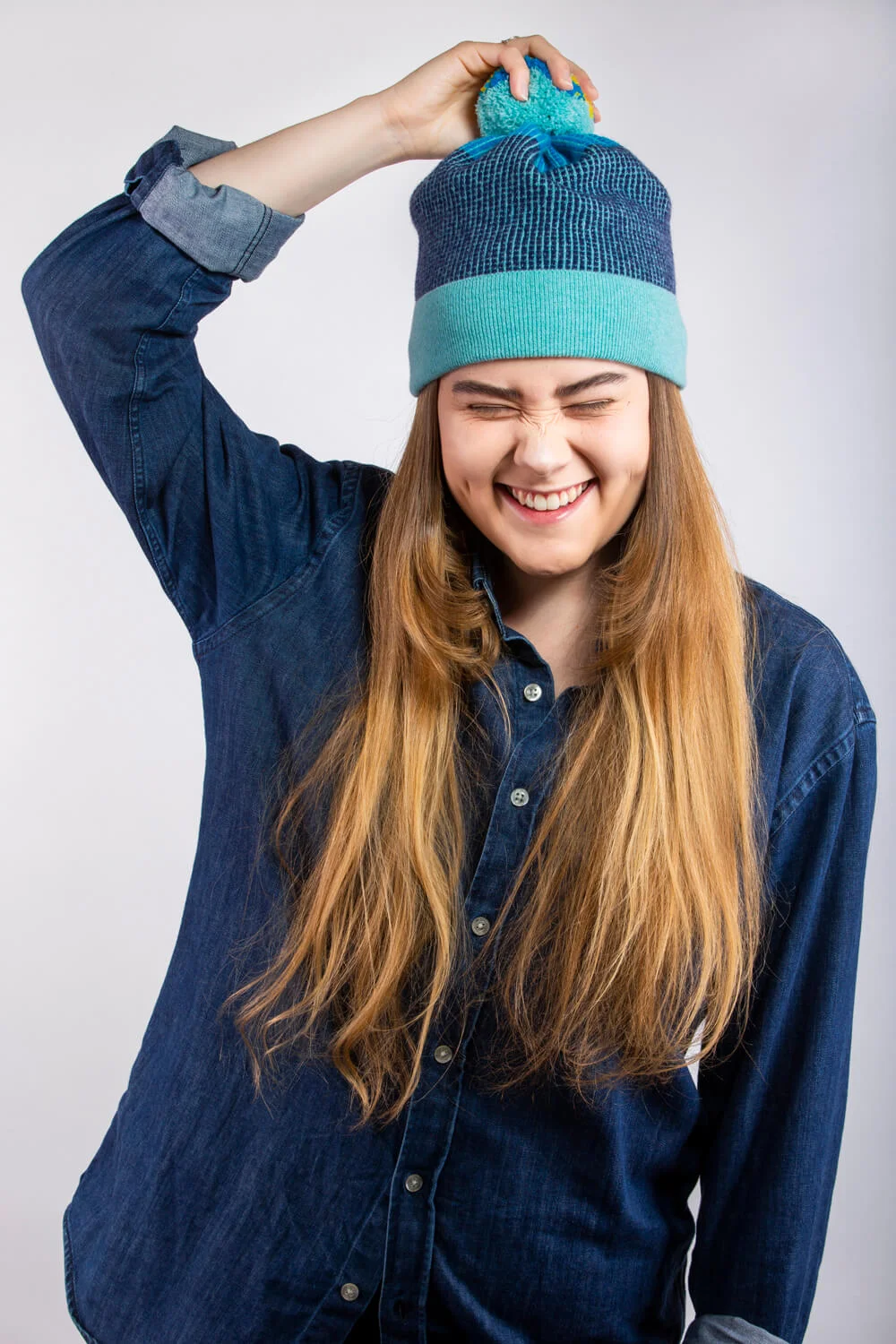 Designer lambswool bobble hat in aqua blue, by Collingwood-Norris. Luxury Knitwear made in Scotland