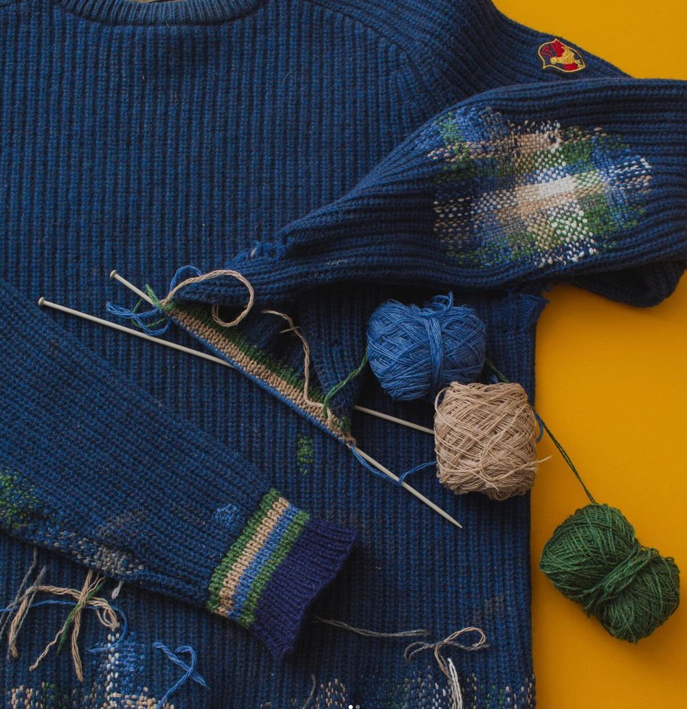 Navy blue rib jumper with creative visible mending at the the elbow, by Collingwood-Norris