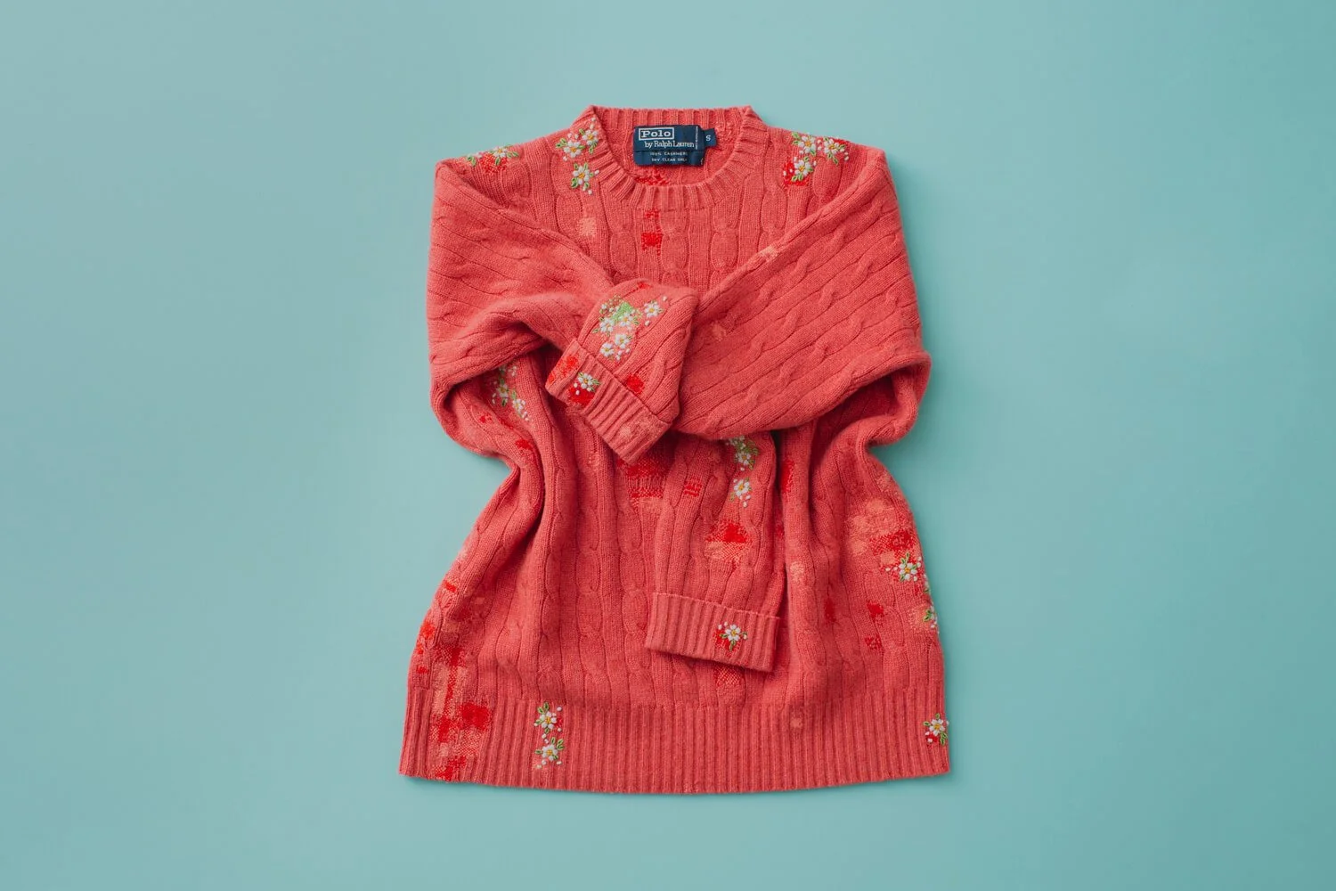 darning and embroidery on a red sweater