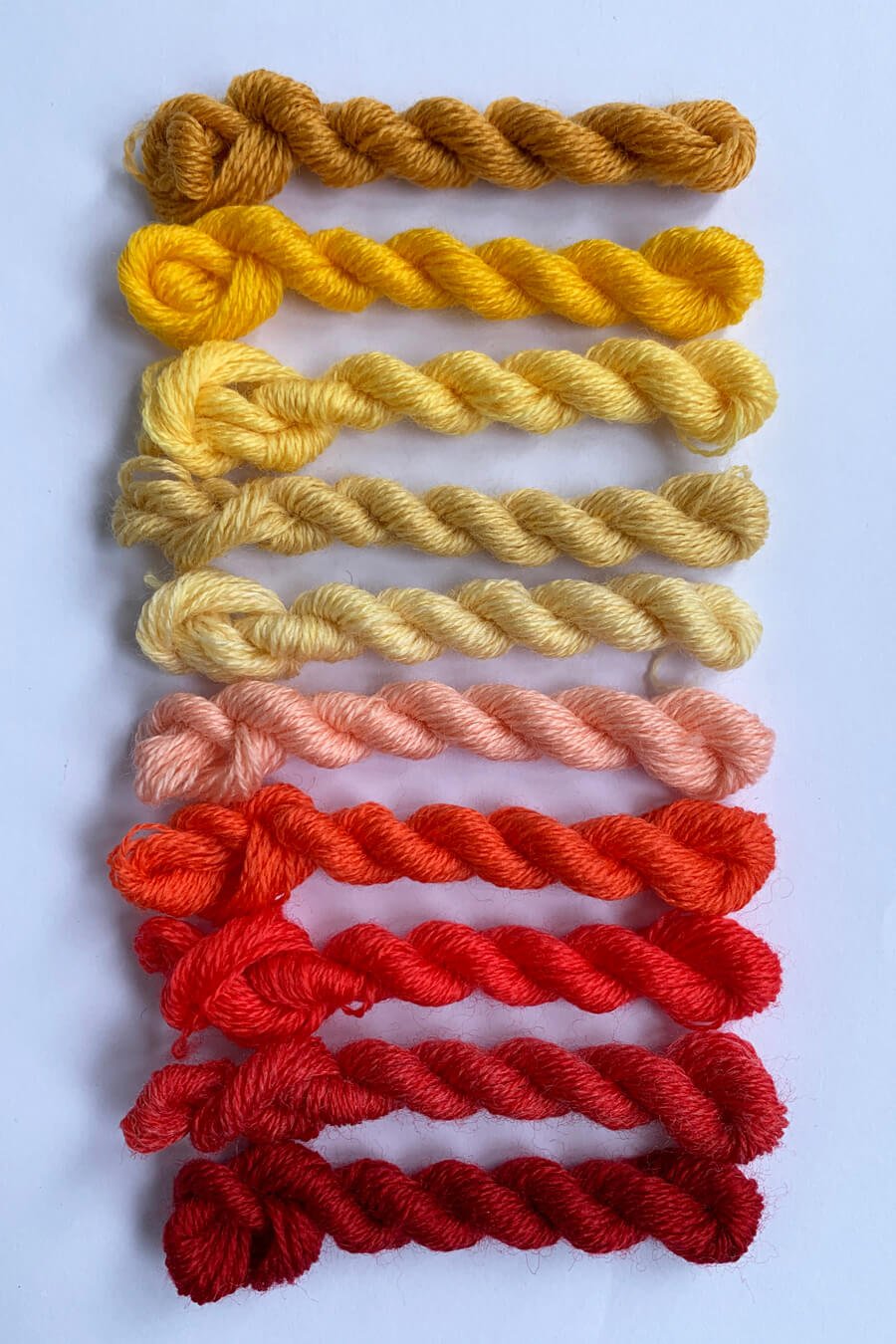 fine merino darning thread in yellows, pinks and red
