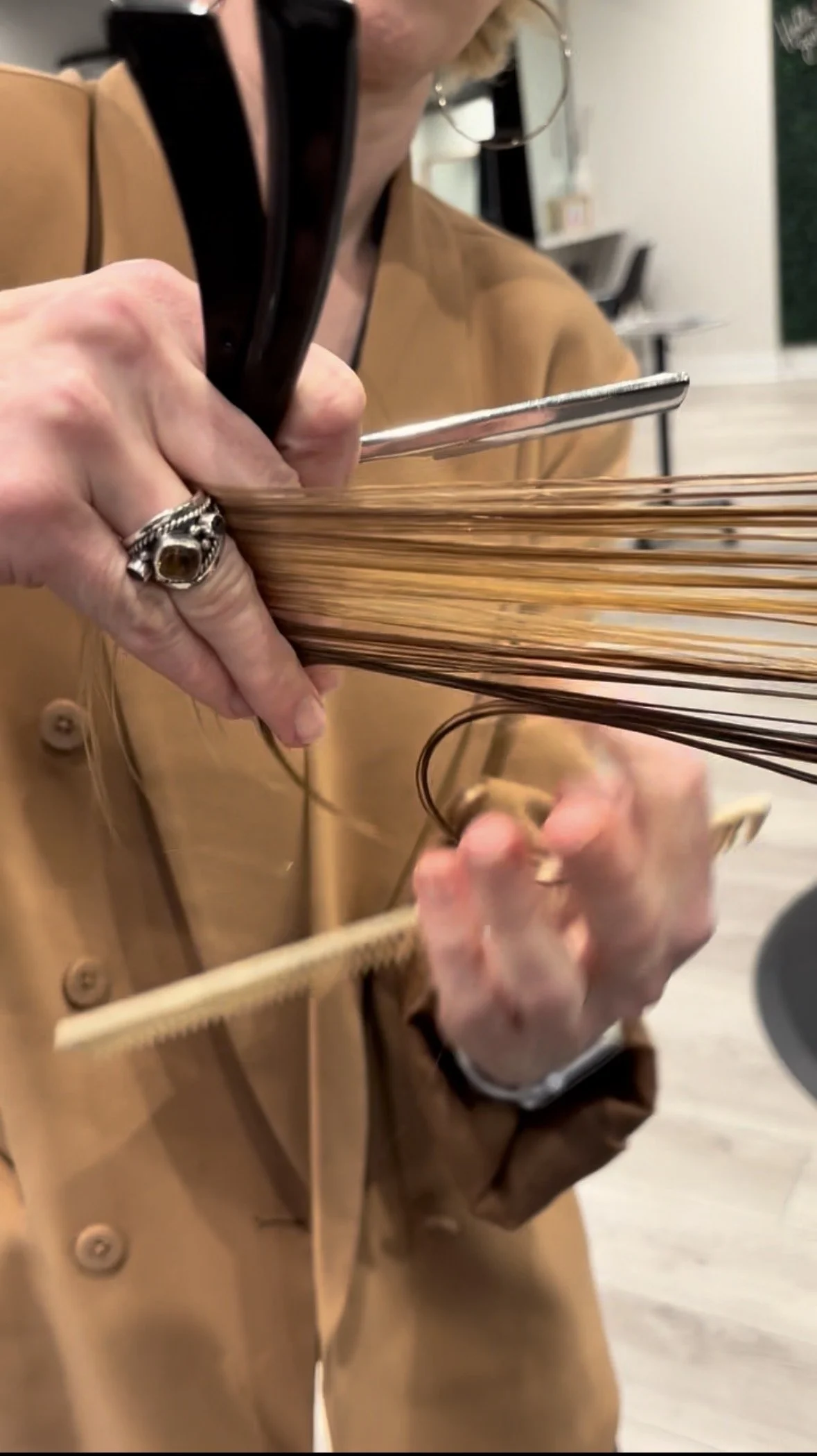 Demonstration of a razor hair cutting class given by educator and director of education. The razor creates texture and movement into the hair.