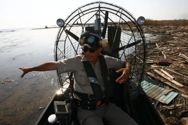 Hector Gonzalez uses his airboat to skim across  debris field in Chambers County after Hurricane Ike.jpg