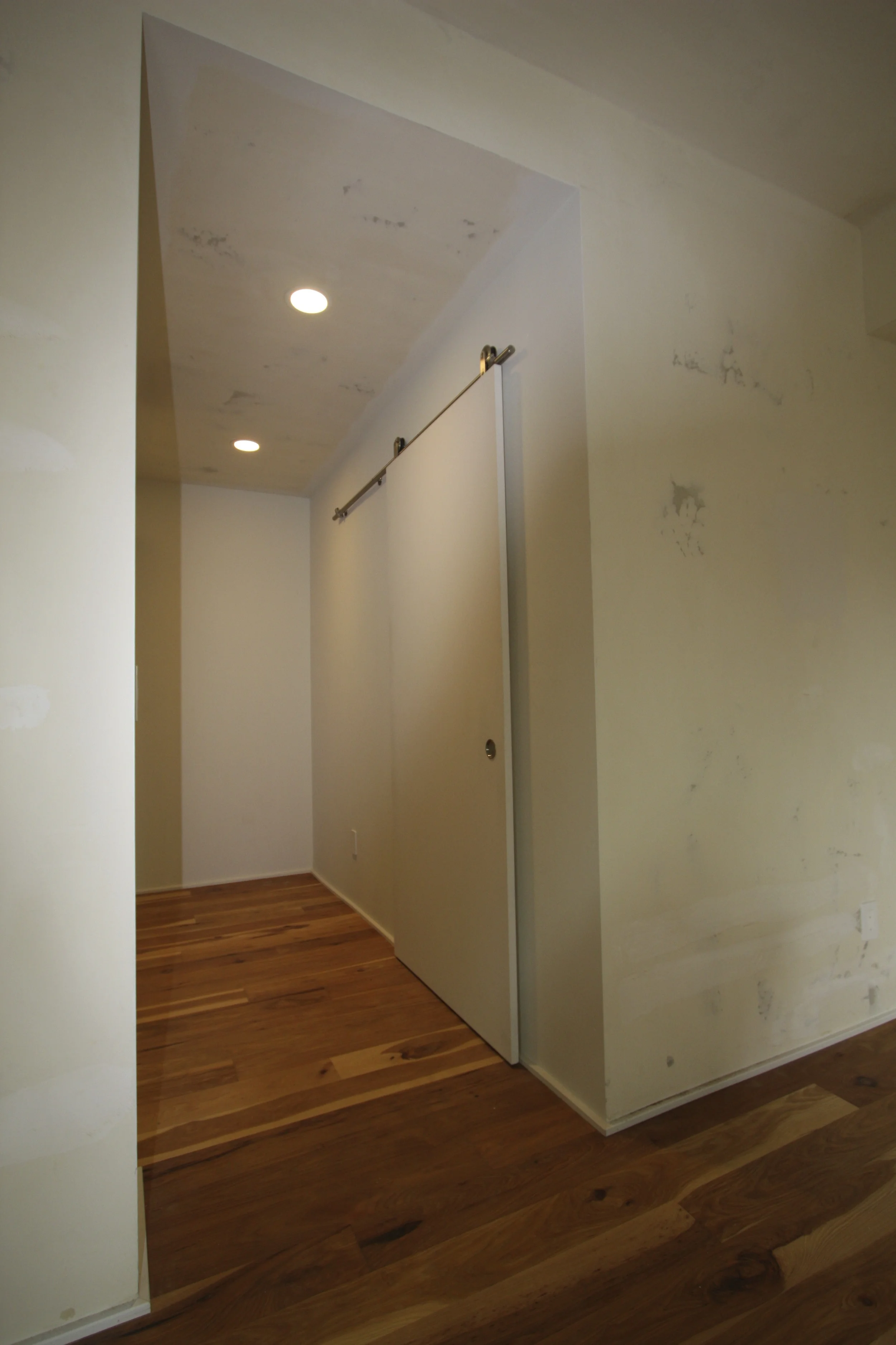 Hall accesses closet, laundry and bath. Sliding ‘barn door’ is seen here.