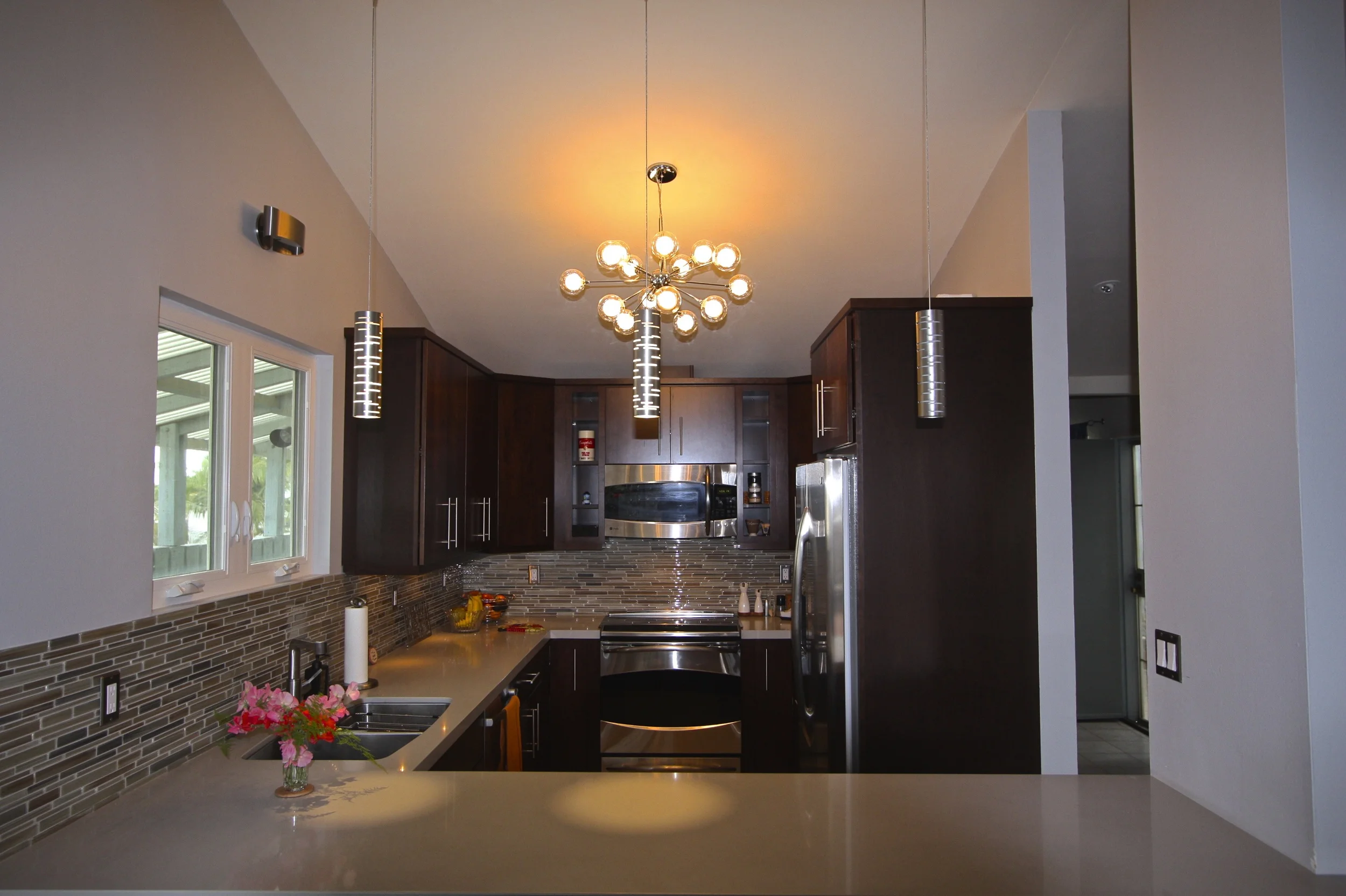 After: Beautiful countertop, backsplash tile and really great modern lighting.