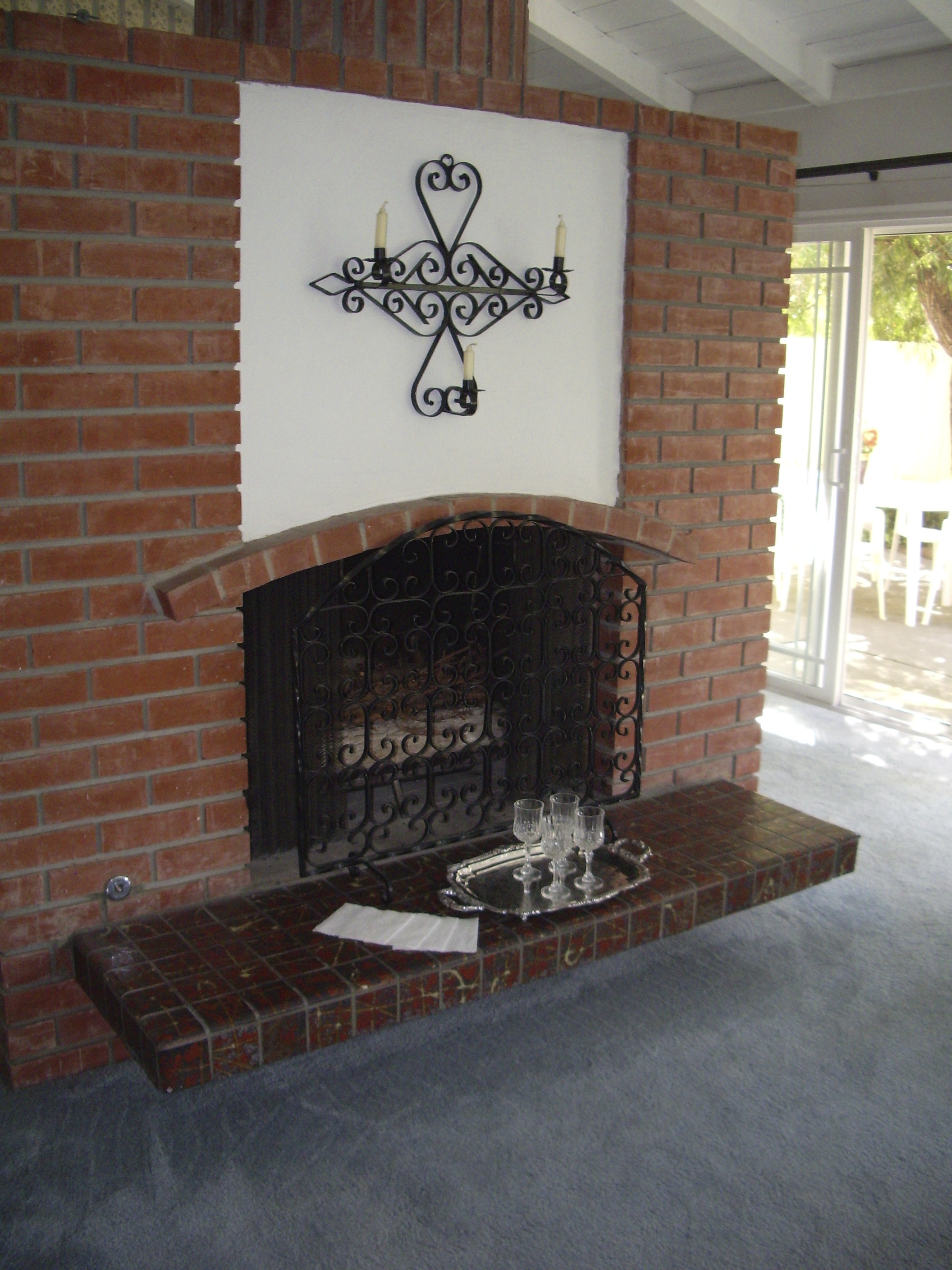 Before: Original brick fireplace, blue carpeting was throughout the house.