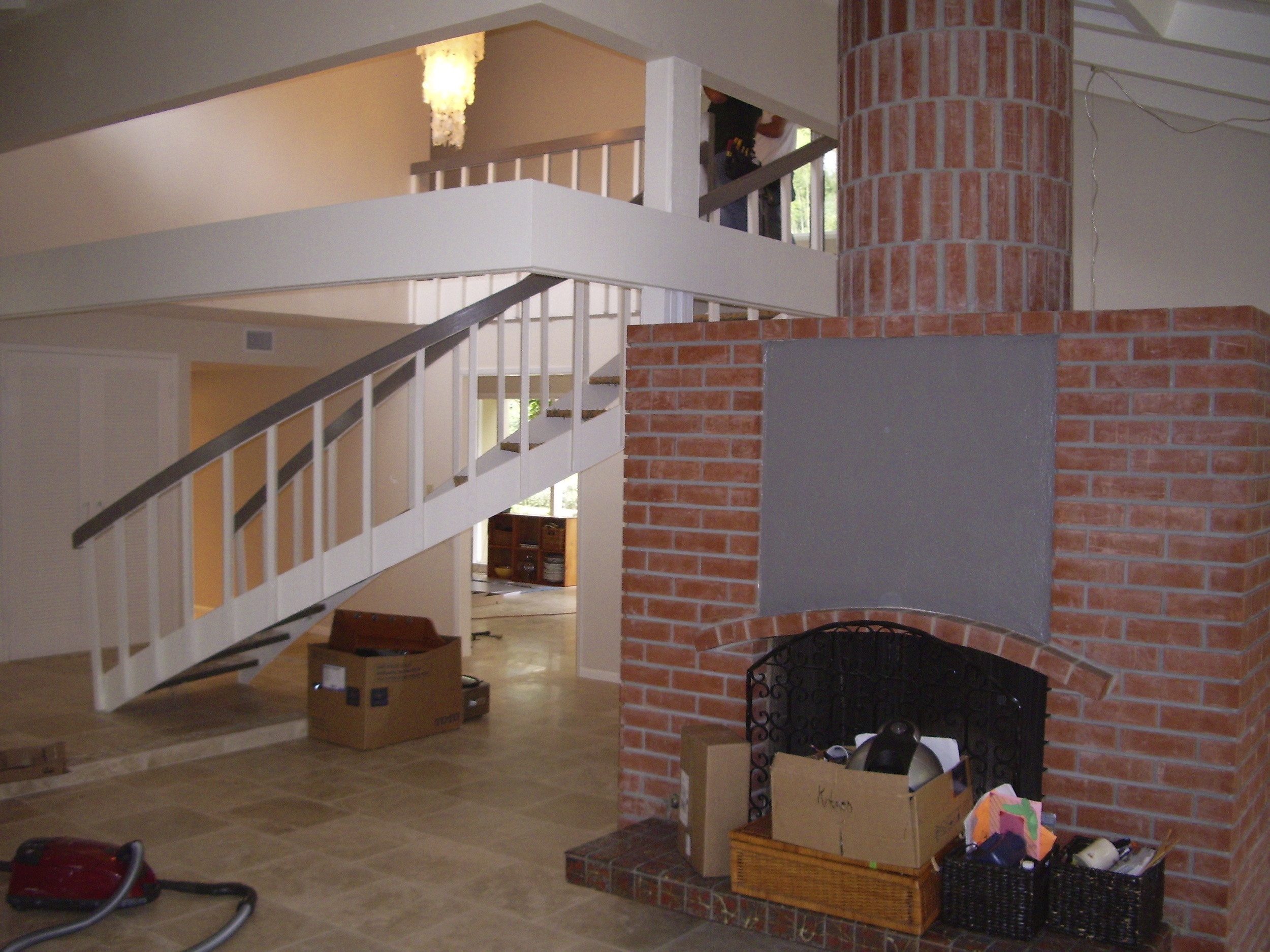  After: The only change to the fireplace was painting the white stucco. Note the great round chimney. All flooring on first floor is&nbsp;18x18 travertine. 