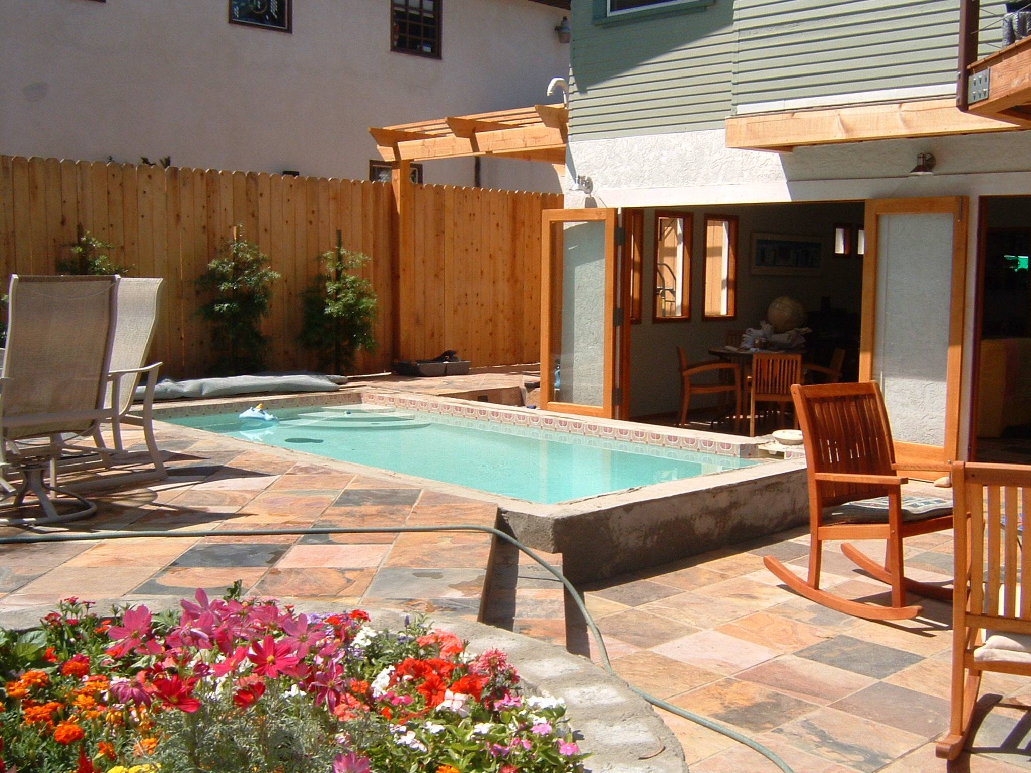  Patio, pool and full opening glass doors create a nearly seamless transition from indoors to outdoors. 