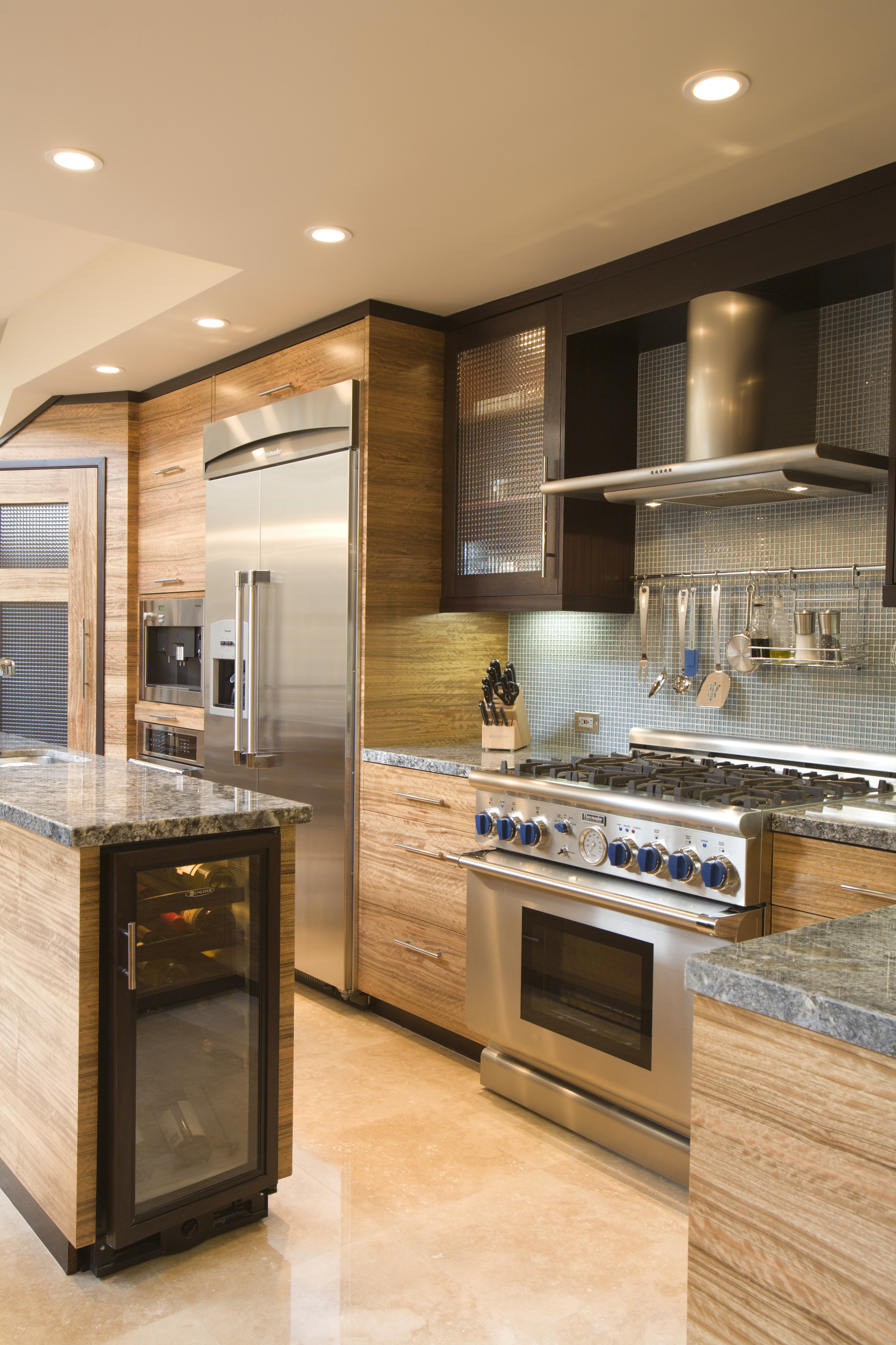  Kitchen features cabinetry of wenge and pal deo. 