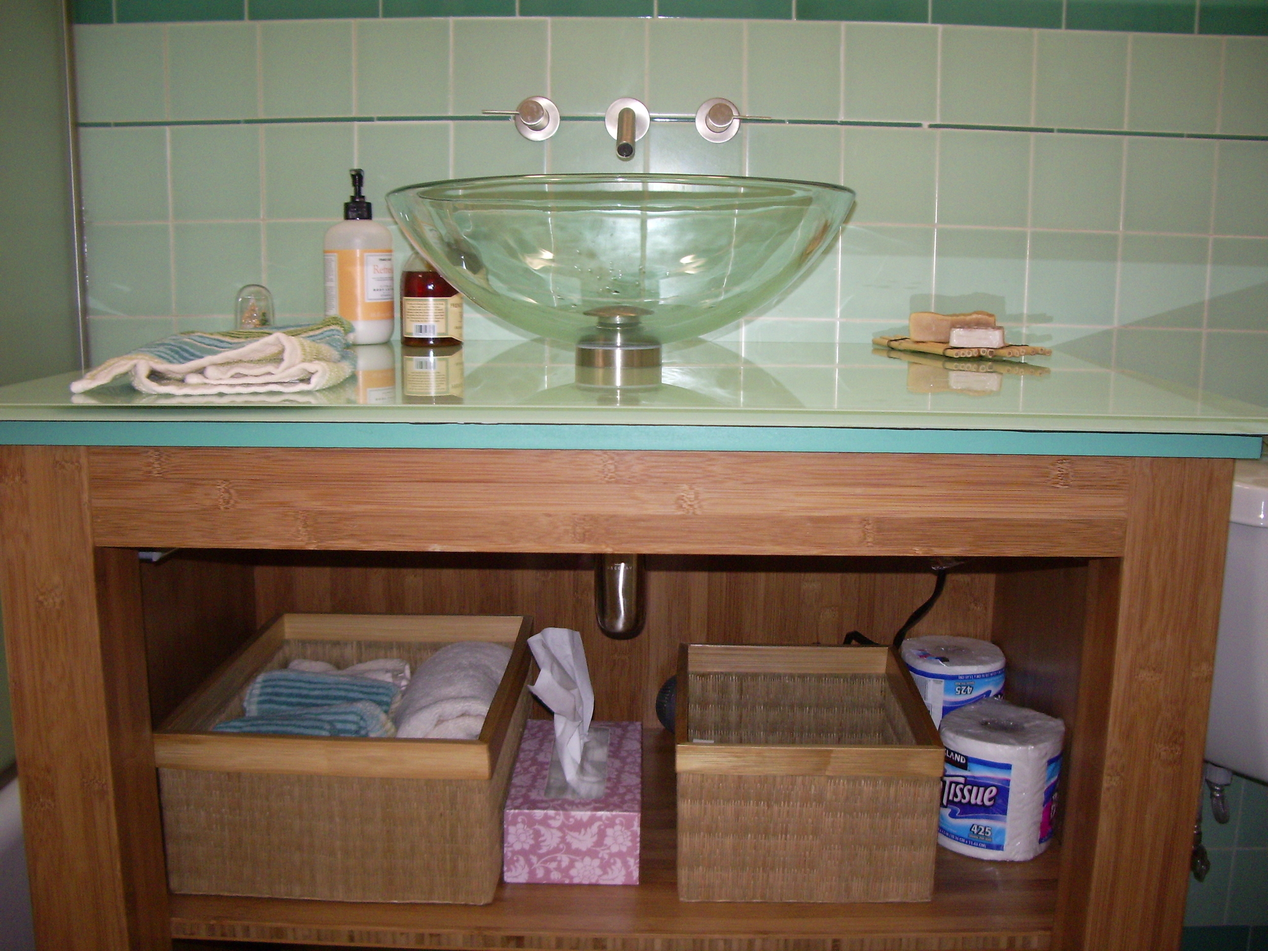  After:&nbsp;Bamboo plywood vanity with custom&nbsp;back-painted glass countertop. 