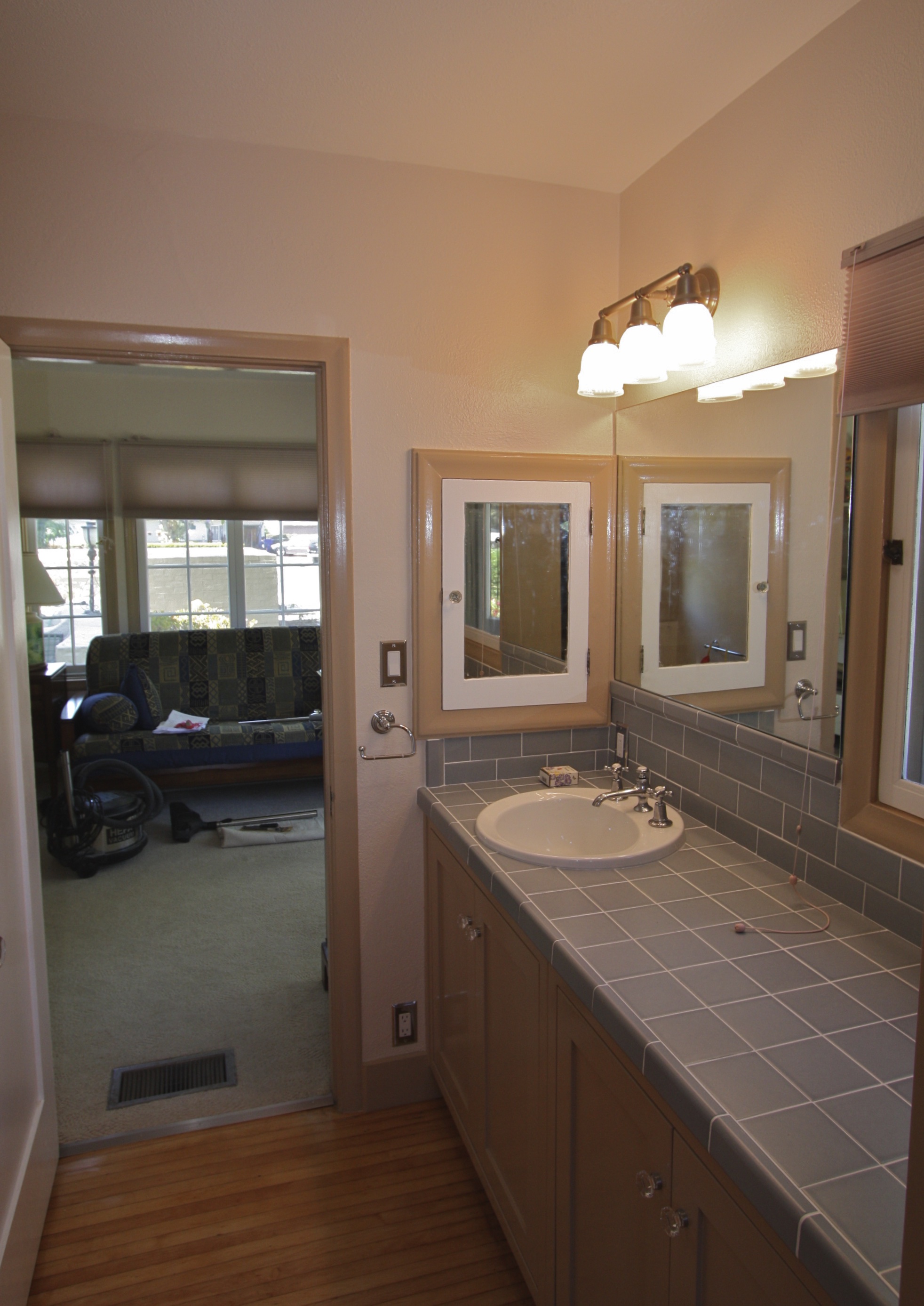  After: New cabinets with tile countertop, wood floor under carpet was refinished.&nbsp;Several original features remain and new components done in a way to look older. 