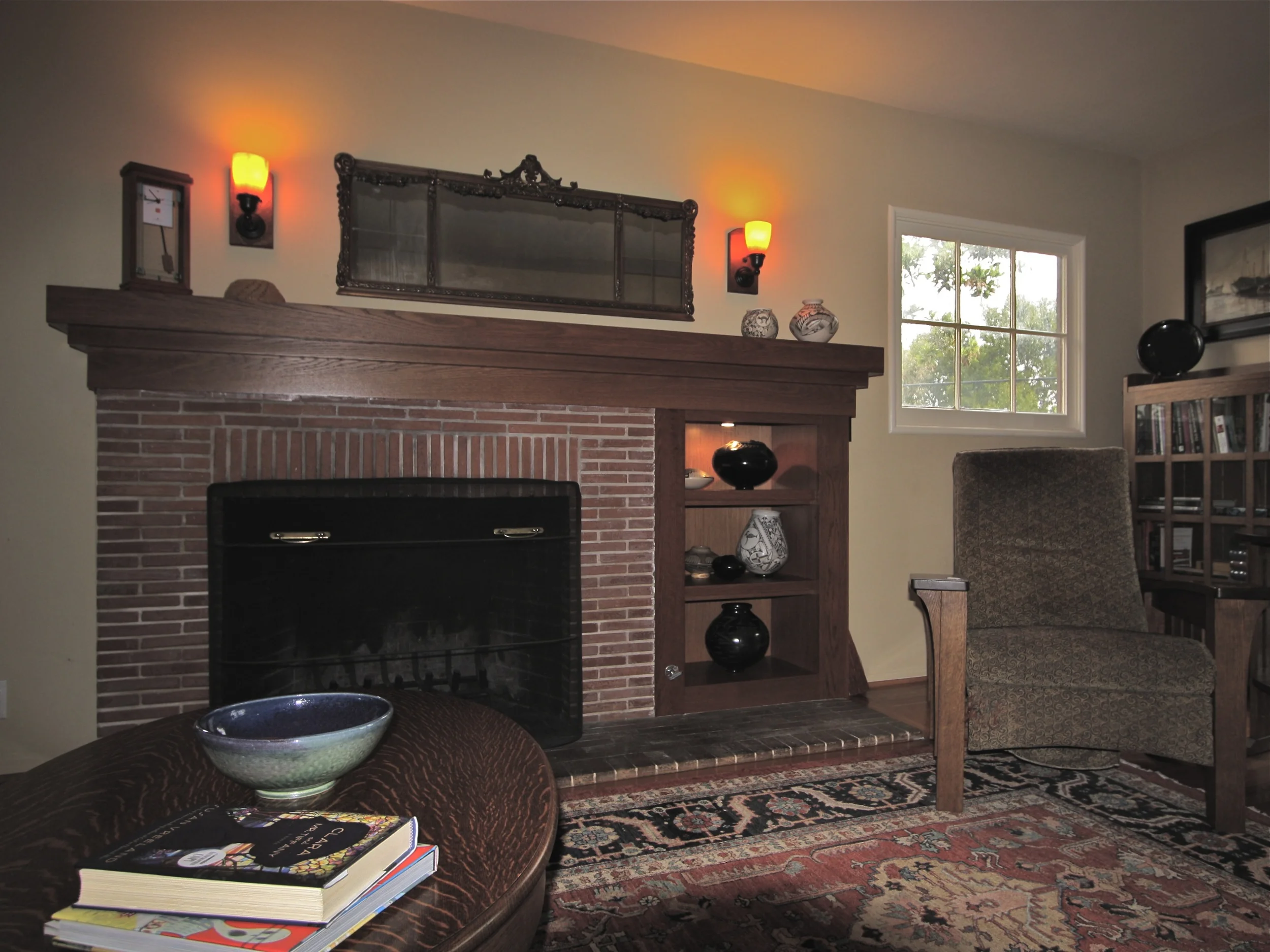 After: New mantle and art shelves to replace painted mantle and log storage.