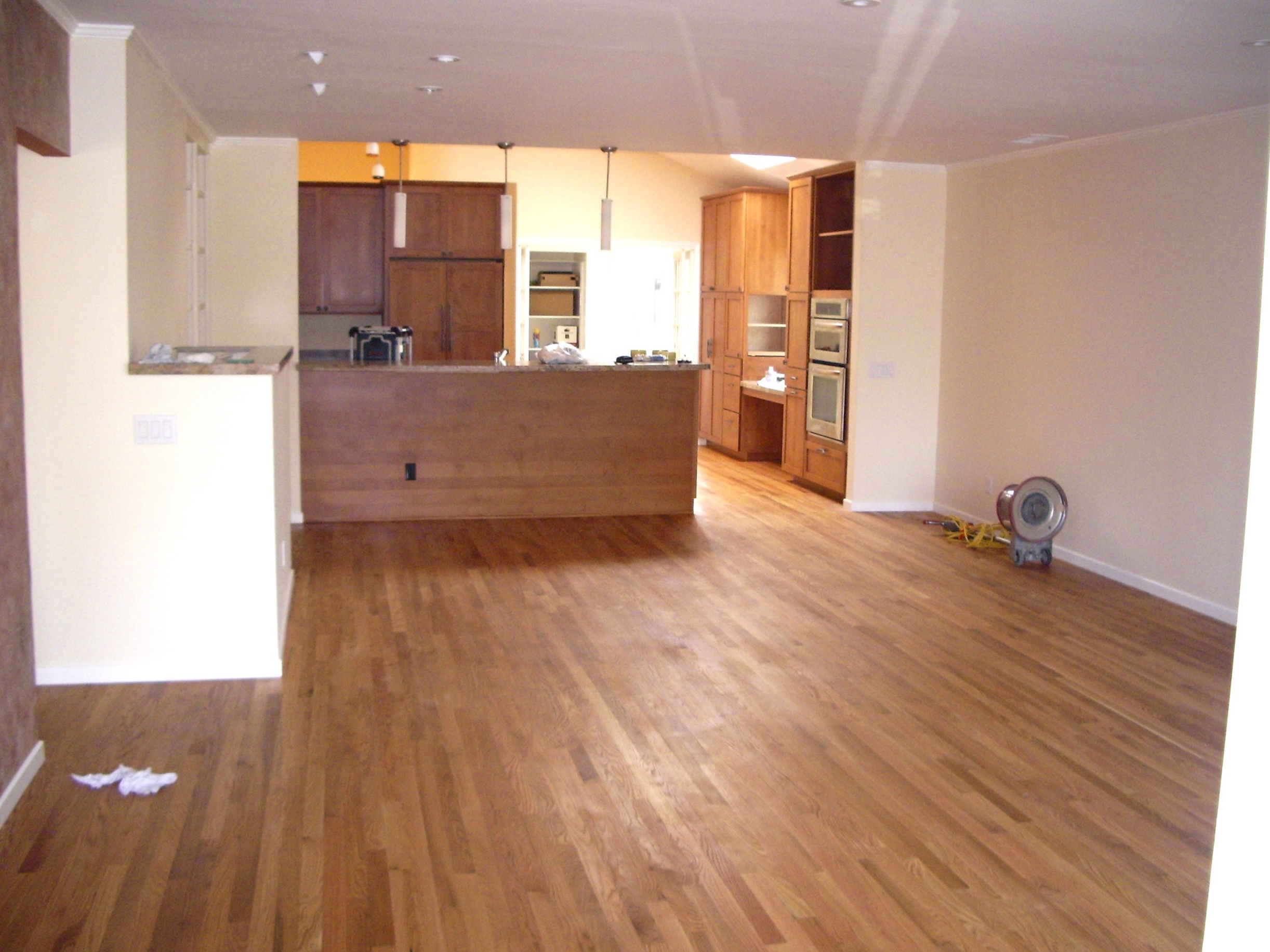 The floor is a combination of new and existing oak strip flooring that was sanded and finished with an all natural resin/oil and waxed.