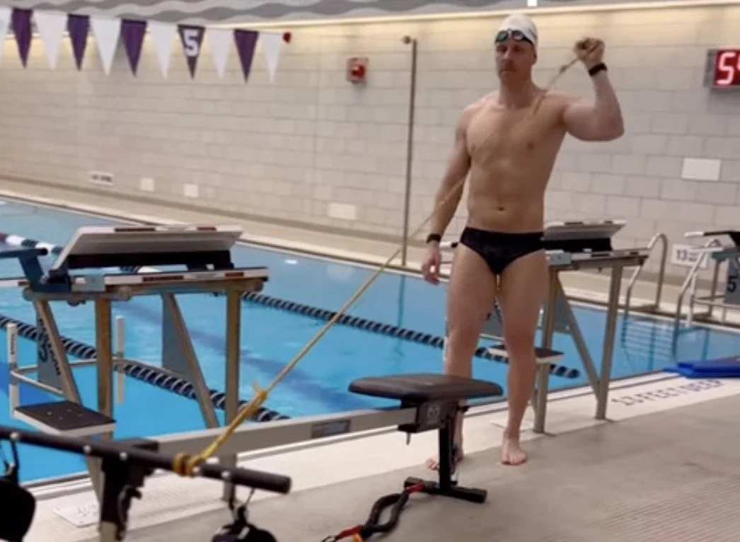 Coach Dan Daly  shows worm up exercises on deck