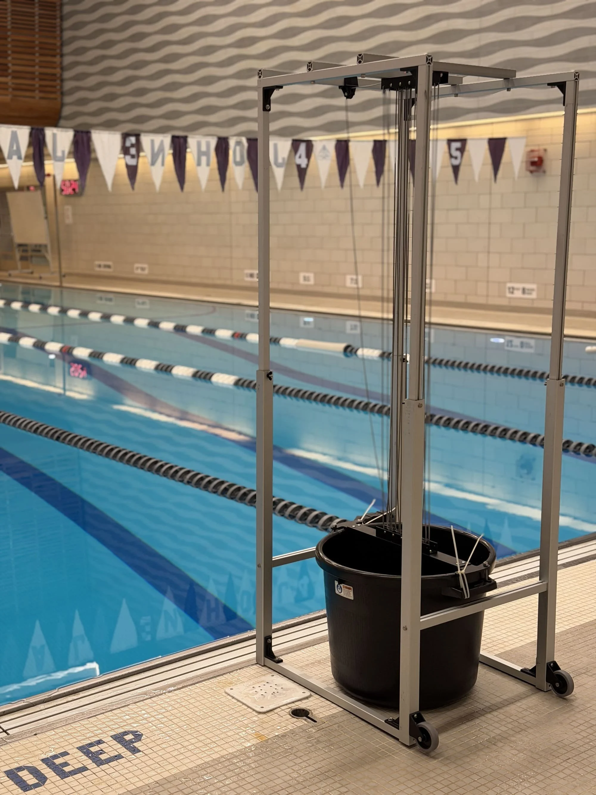 Destro Swim Tower with SwiMeter 2.0 displaying power and velocity metrics during swim training at john jay college swimming pool