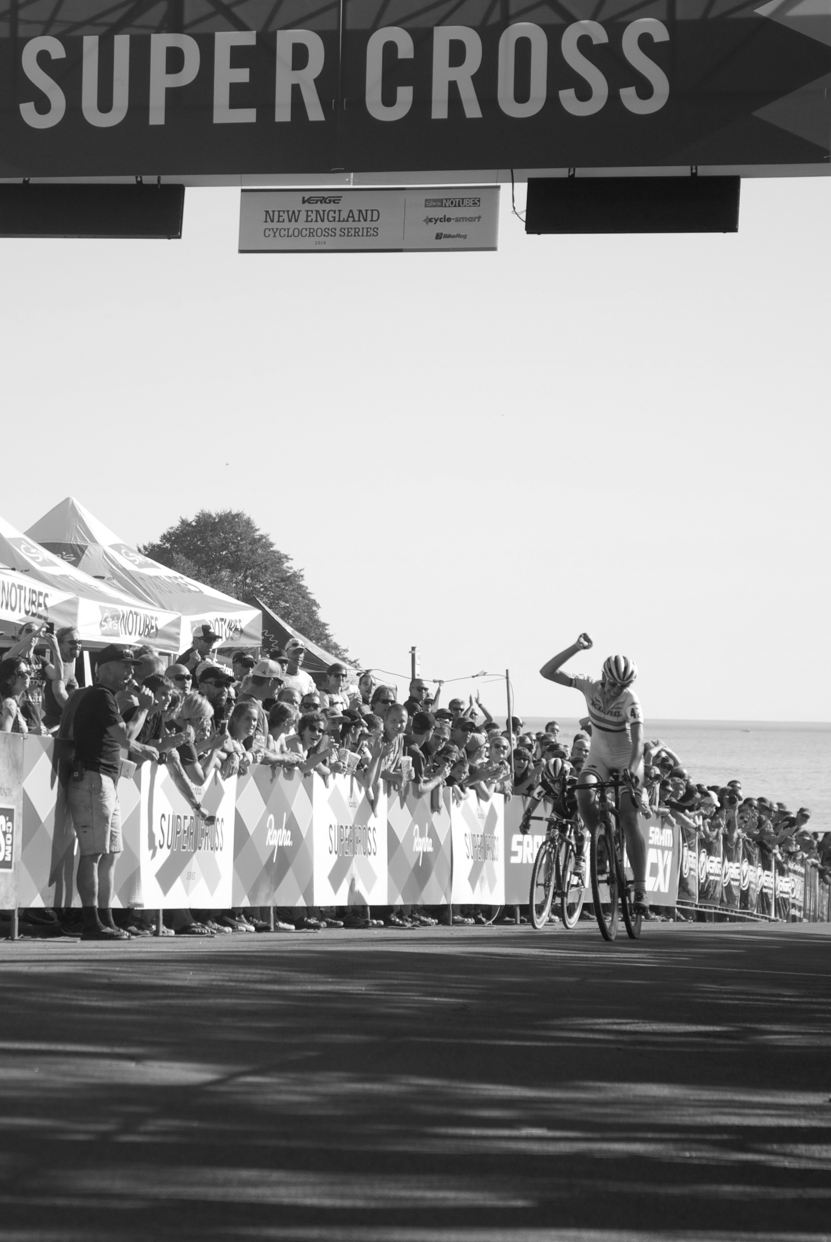 Helen Wyman celebrates her win as she crosses the finish line on Day 1 of the RSC UCI Pro Women's Race