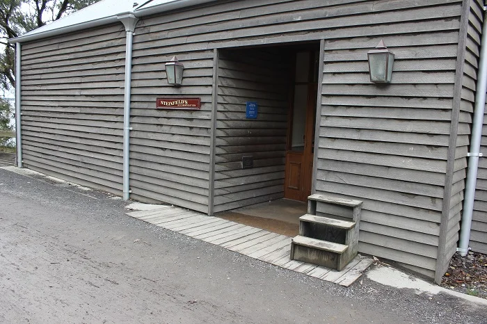 Most buildings (including houses) had some kind of porch. Was it to wipe your shoes and keep mud and dust outside?