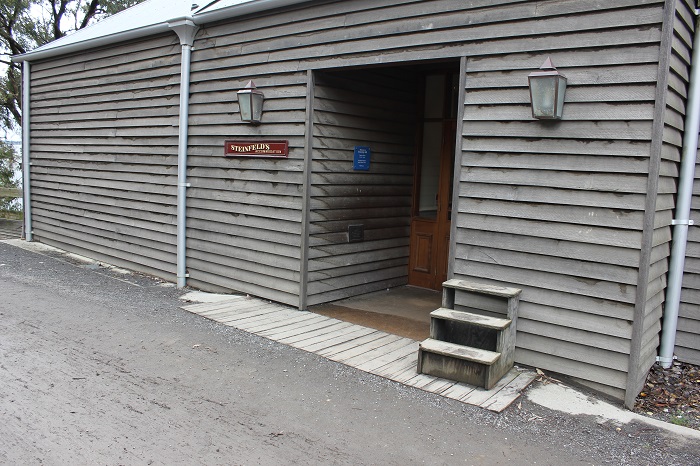 Most buildings (including houses) had some kind of porch. Was it to wipe your shoes and keep mud and dust outside?