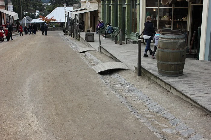 On this street lined with buildings, all of the porches are linked together, forming something that represents a modern sidewalk. Its purpose is not to segregate traffic though, since other than the odd horse the only traffic was people!