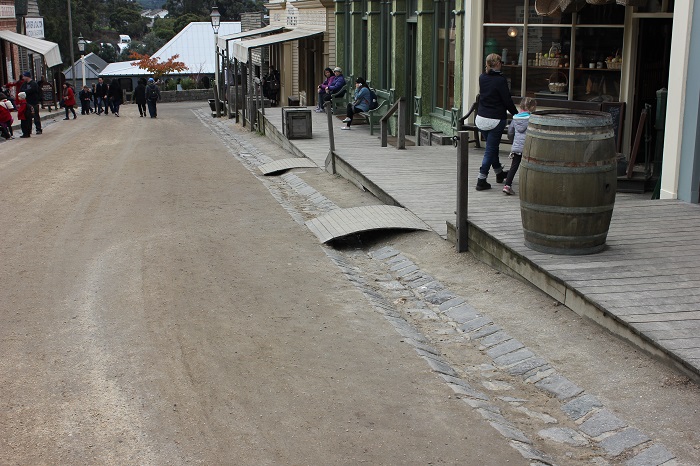 On this street lined with buildings, all of the porches are linked together, forming something that represents a modern sidewalk. Its purpose is not to segregate traffic though, since other than the odd horse the only traffic was people!