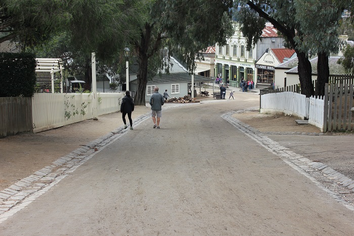 A street with paved drains, but no sidewalks. Sidewalks wouldn't have a served a purpose anyway since there was nothing to segregate.