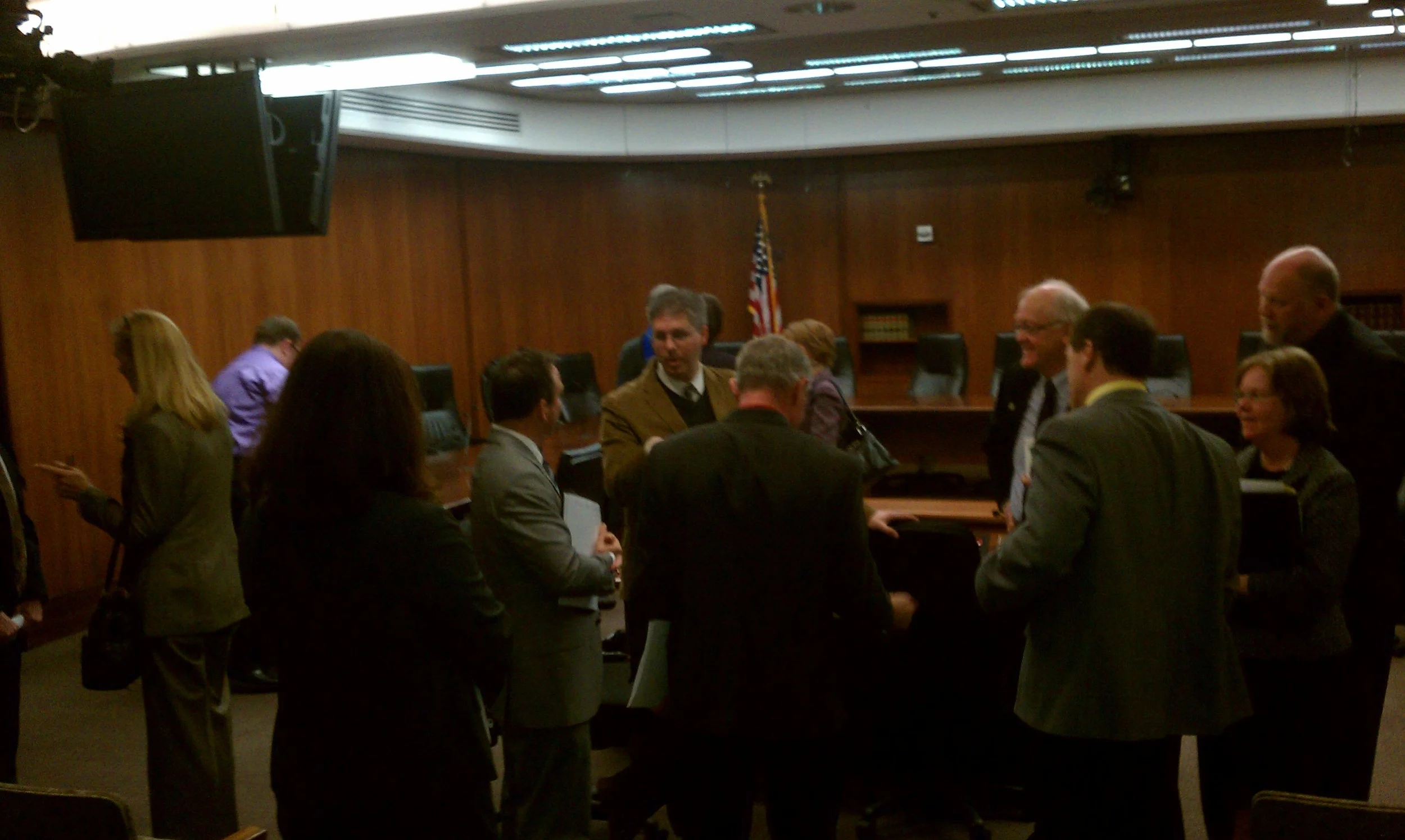 Strong Towns President Charles Marohn small talking with a bi-partisan group of lawmakers after testifying at the Minnesota Legislature. 