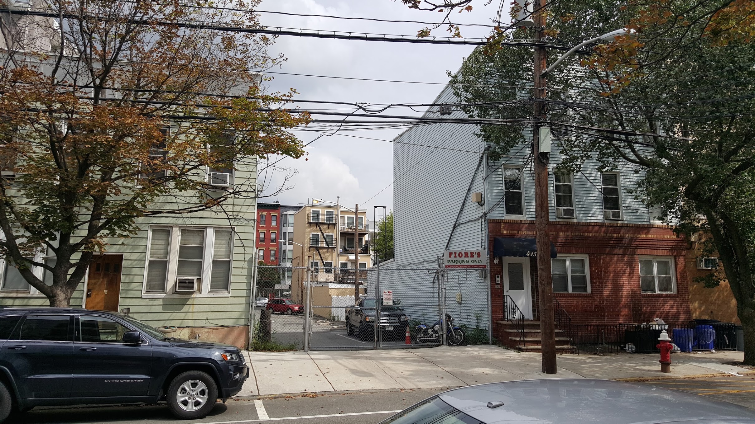 Off-street parking is typically considered "bad urbanism", but in this case it is limited to a single lot. When ugly buildings, undeveloped lots, etc. are limited to the occasional lot, they do not make much of an impact on the overall environment.