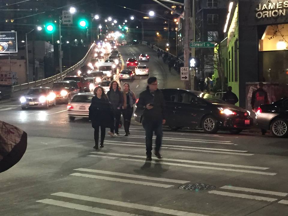 Workers face a gauntlet of cars as they walk to work from the dense Seattle Capitol Hill neighborhood to the employment center of South Lake Union. Transit along this corridor is infrequent and unreliable in part because of traffic congestion.