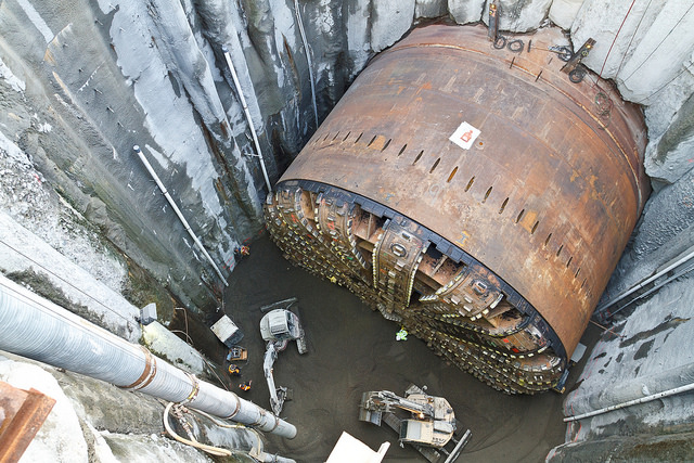 Bertha struck a steel pipe in December 2013, which supposedly caused the breakdown that sidelined the TBM for more than two years. The contractor had to dig the TBM out and hoist it to the surface to conduct the repairs to get it running again. Incidentally, the excavation pit probably was the cause of Pioneer Square sinking more than an inch. ( WSDOT )