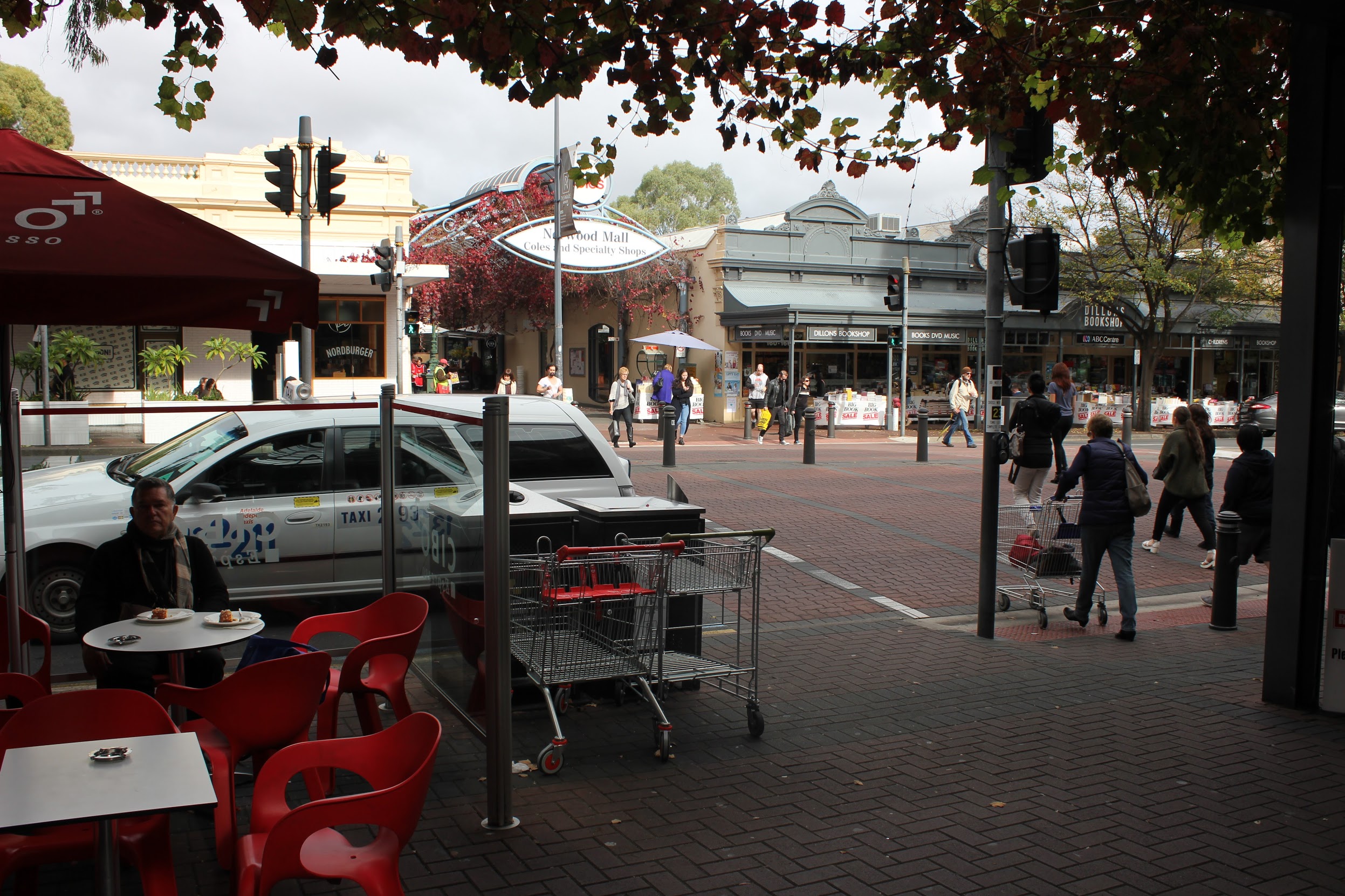 Traffic lights and a crosswalk midway up a block in Adelaide.