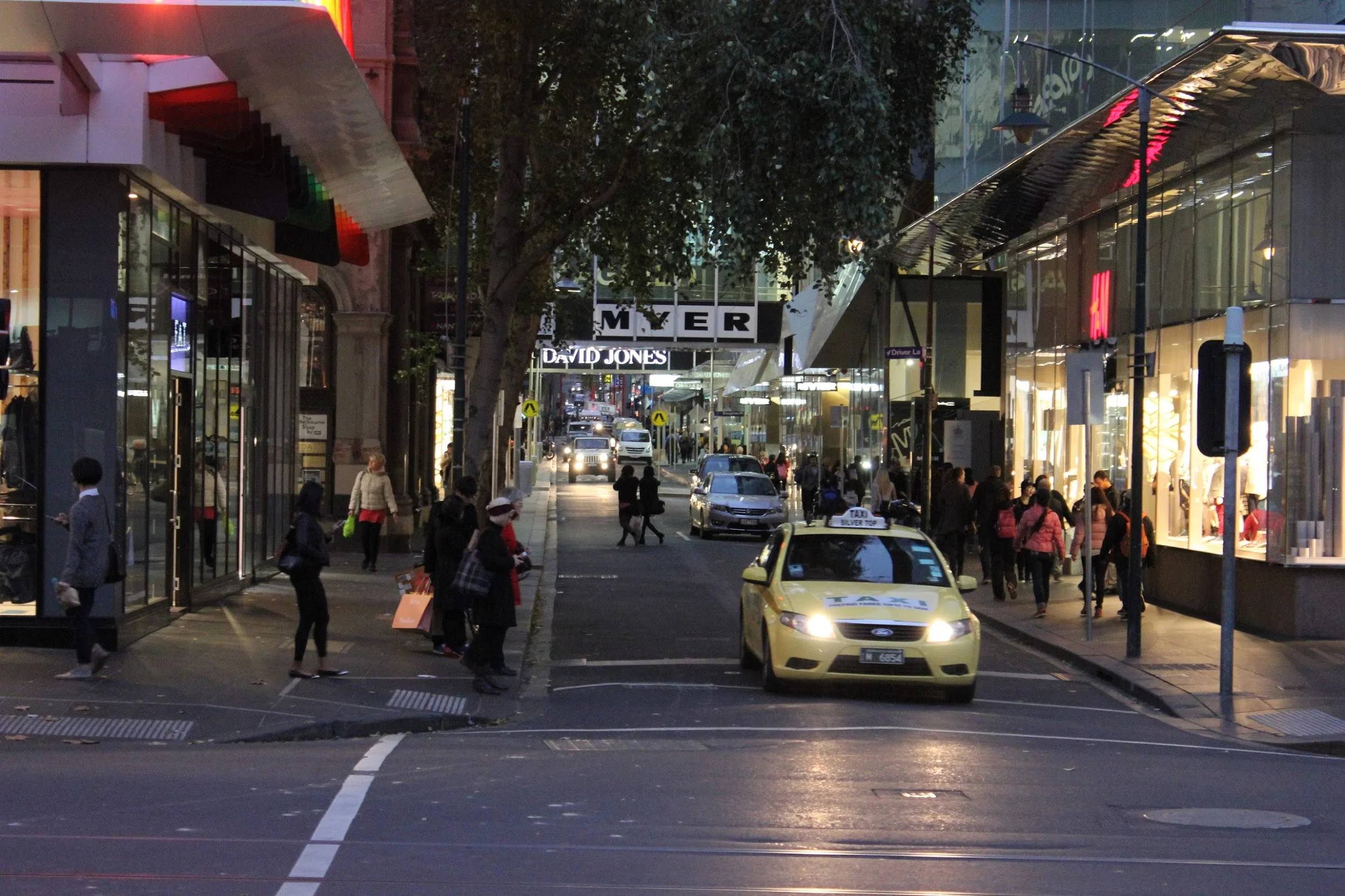 People jaywalking a street in Melbourne.