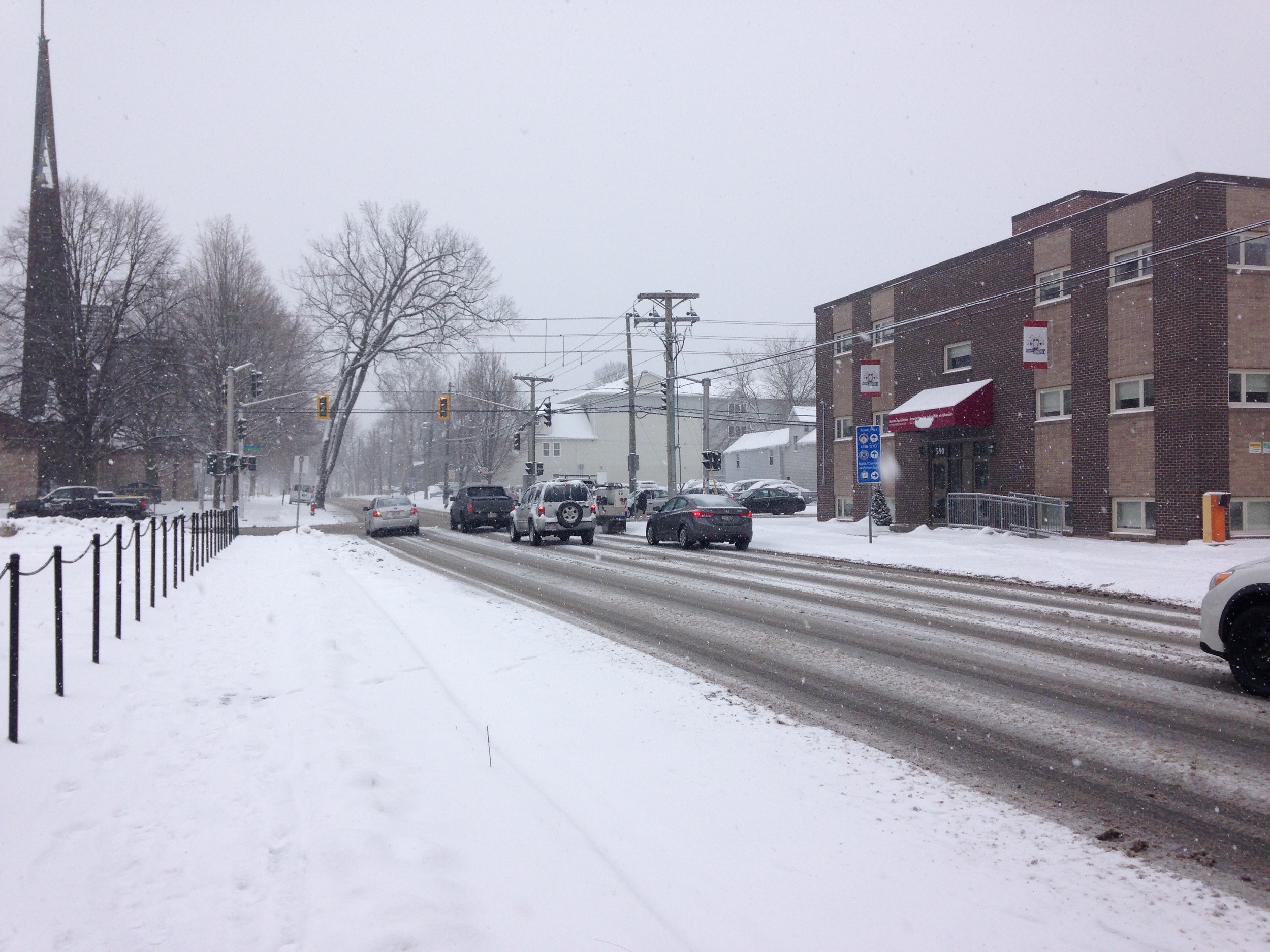 A three-lane segment of Brunswick Street right before the market. I took this picture during a snow storm power outage, which meant that this intersection became accidental shared space with no traffic-lights. Everyone slowed down, yielded to pedestrians, and no one was hurt.