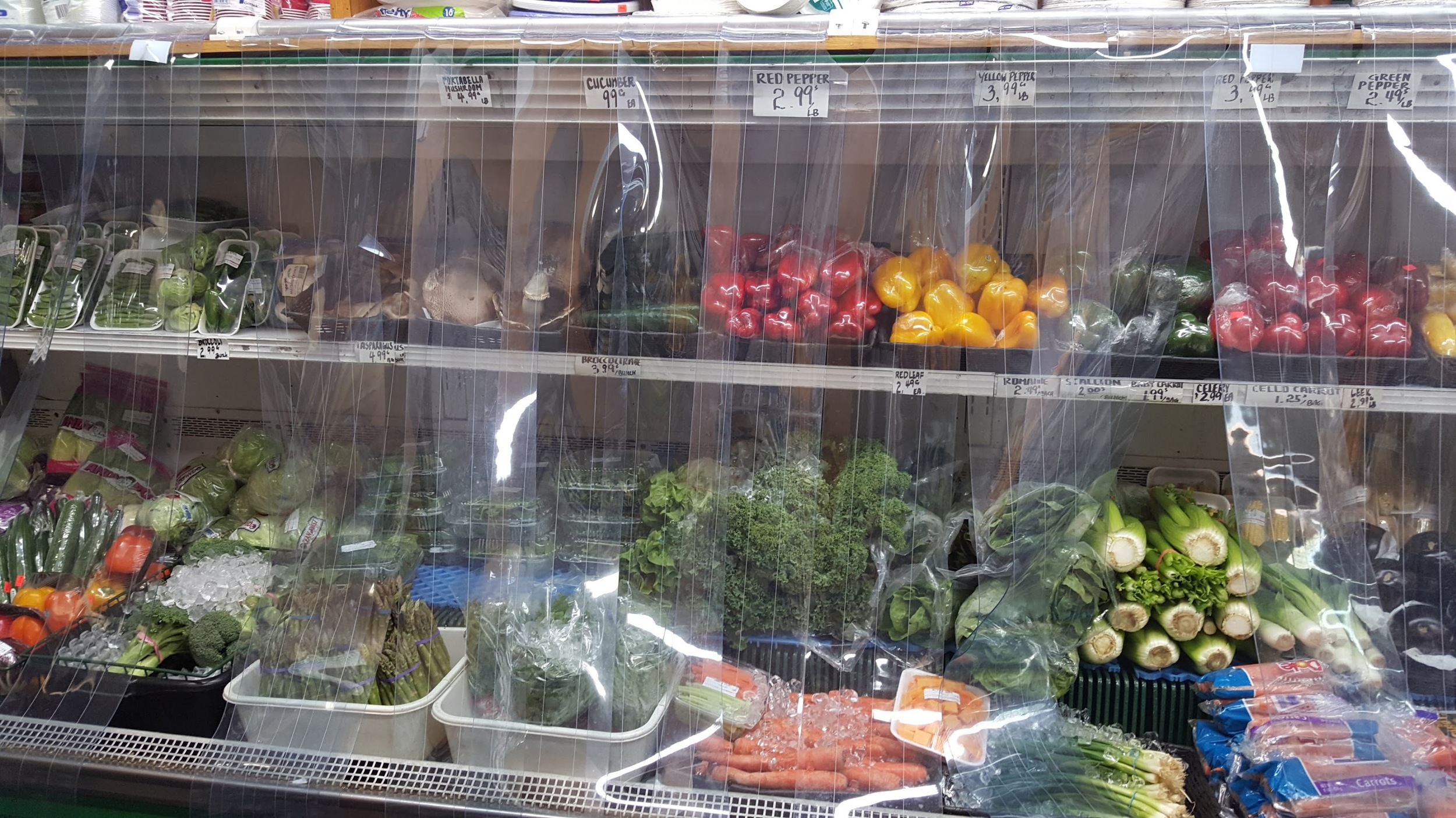 The produce area at the back of a grocery store.