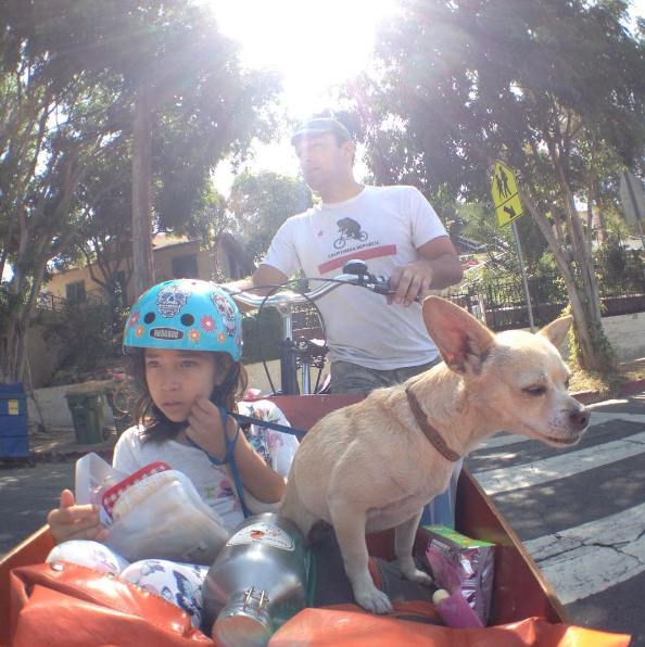 Joe, his daughter and their dog bike to school