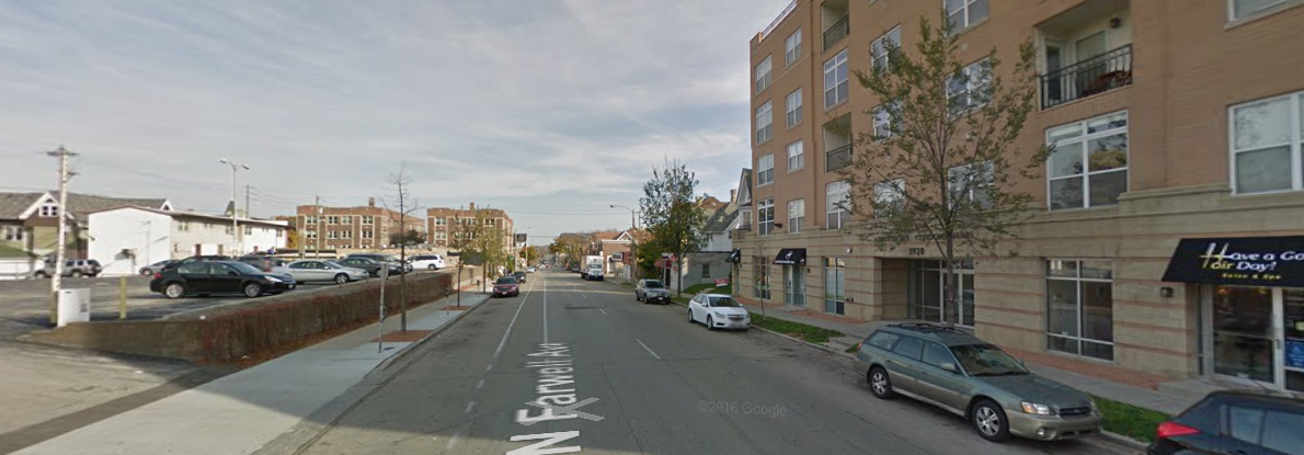 Farwell Ave. On the right is a mixed-use building with several businesses on the bottom floor. On the rleft is a large parking lot. Again, this is taken from the middle of an intersection where I consistently endanger my life trying to cross.
