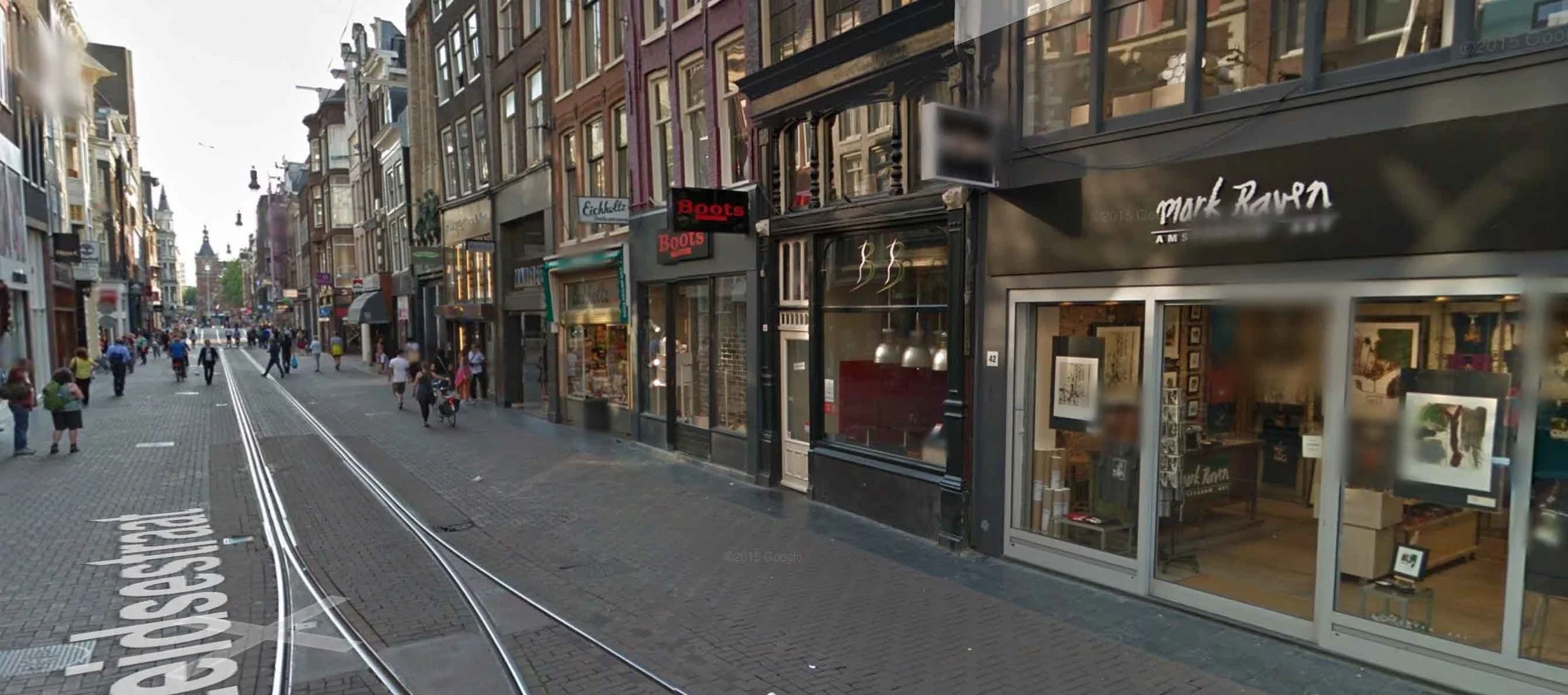 Shops in Amsterdam along a 35 foot wide street. (Map.)