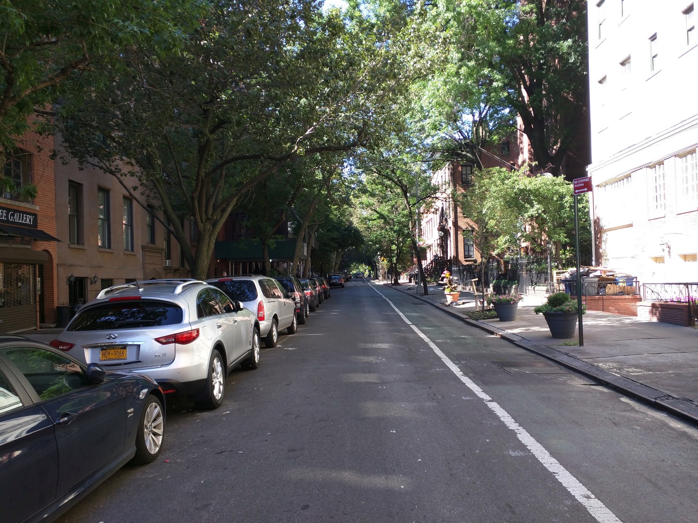 The (fading) green lane --demarcated with white line-- is a bike lane. Of particular importance to walkability are the street trees, as seen in both photos. Street trees provide shade on hot summer days, and a splash of natural color against what would otherwise be a hard urban environment. ( Photo by Alexander Dukes)