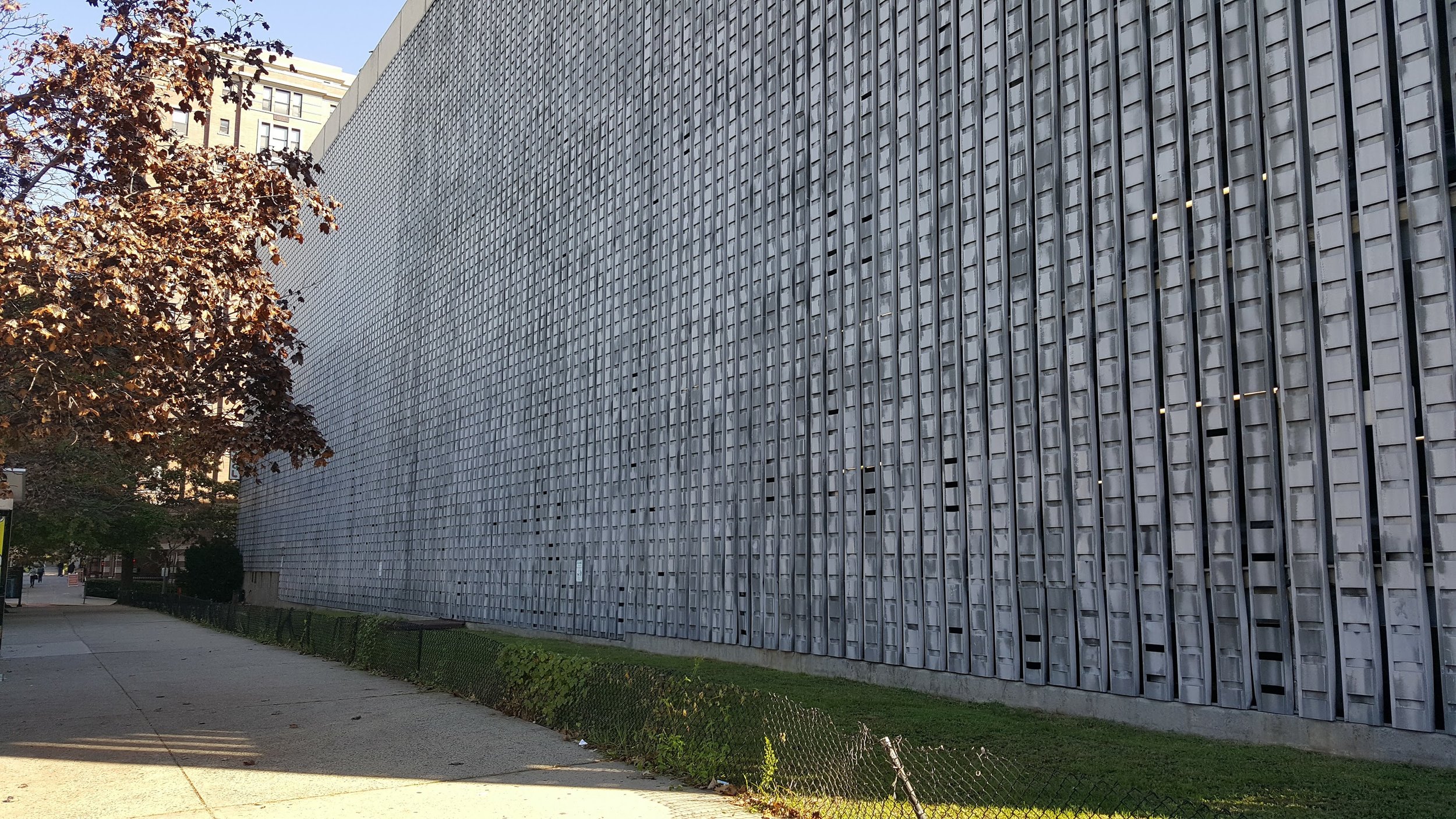 A bad parking garage in Hoboken, NJ that is one long blank wall.