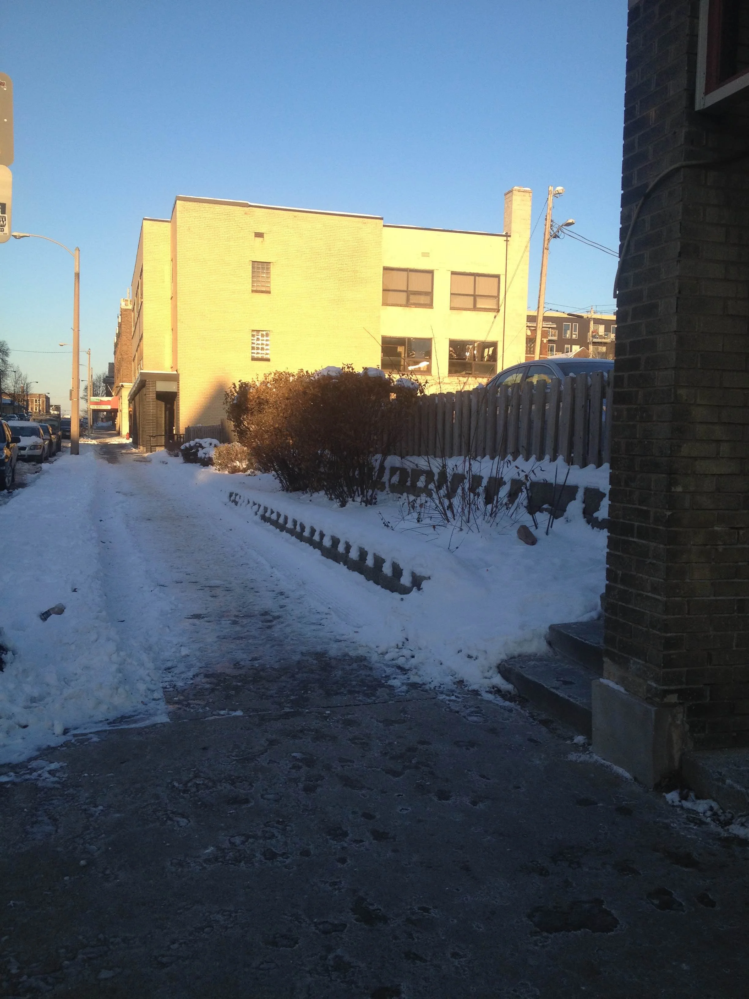 Photo taken a few blocks from my house in Milwaukee, where you can clearly see the shoveling line between the neighborhood pizza parlor (out of frame to the right) and the surface parking lot next door.