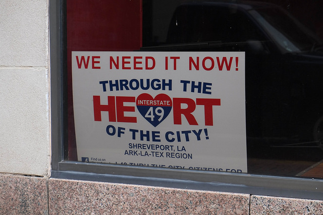 Voting against your interests? A pro-highway poster found in the window of a Shreveport business. (Photo by Paul Sableman )