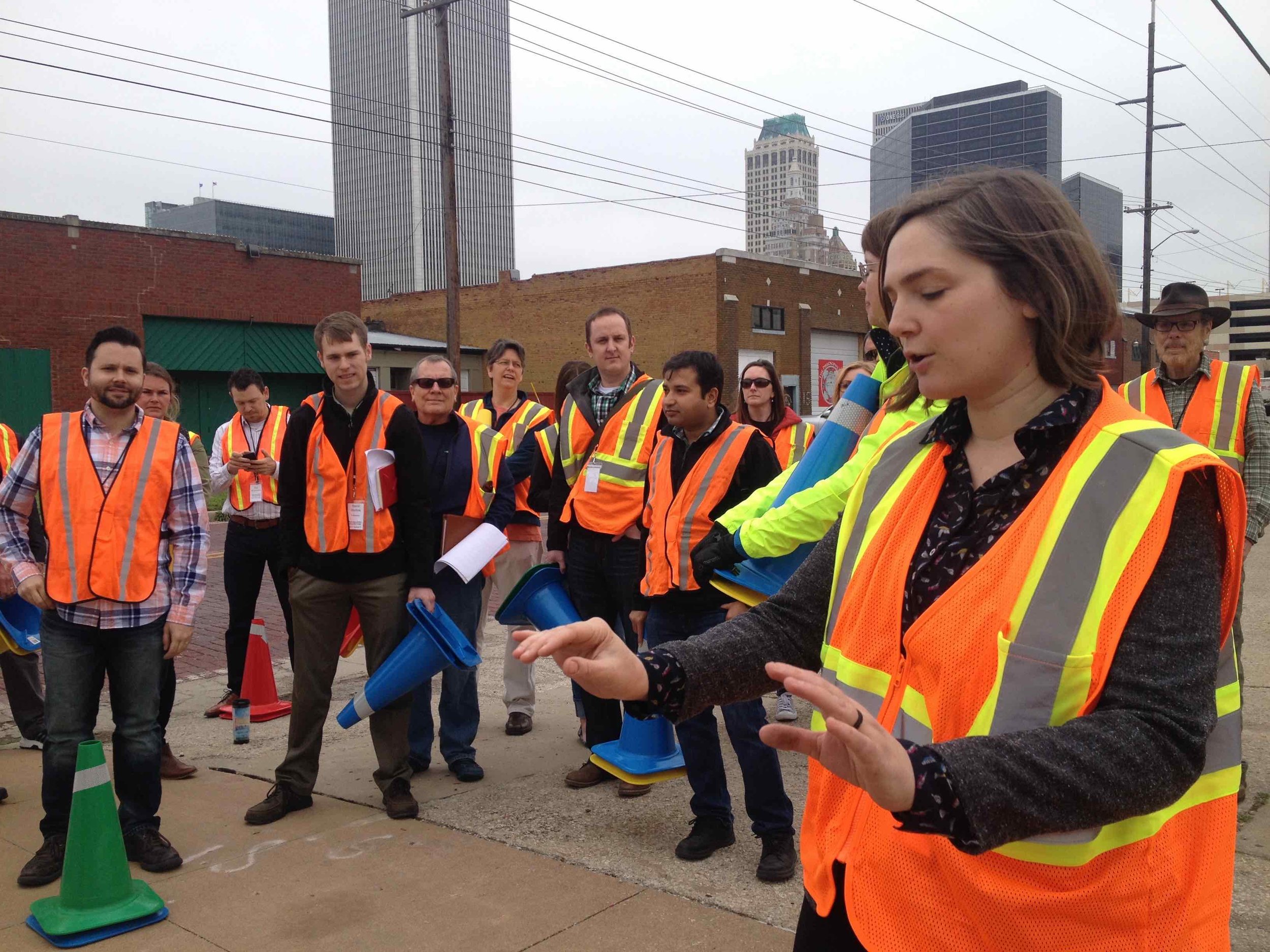 Marielle Brown (front, right) preps a group of Summit attendees to participate in a traffic calming demonstration. Daniel Herriges is pictured far left.